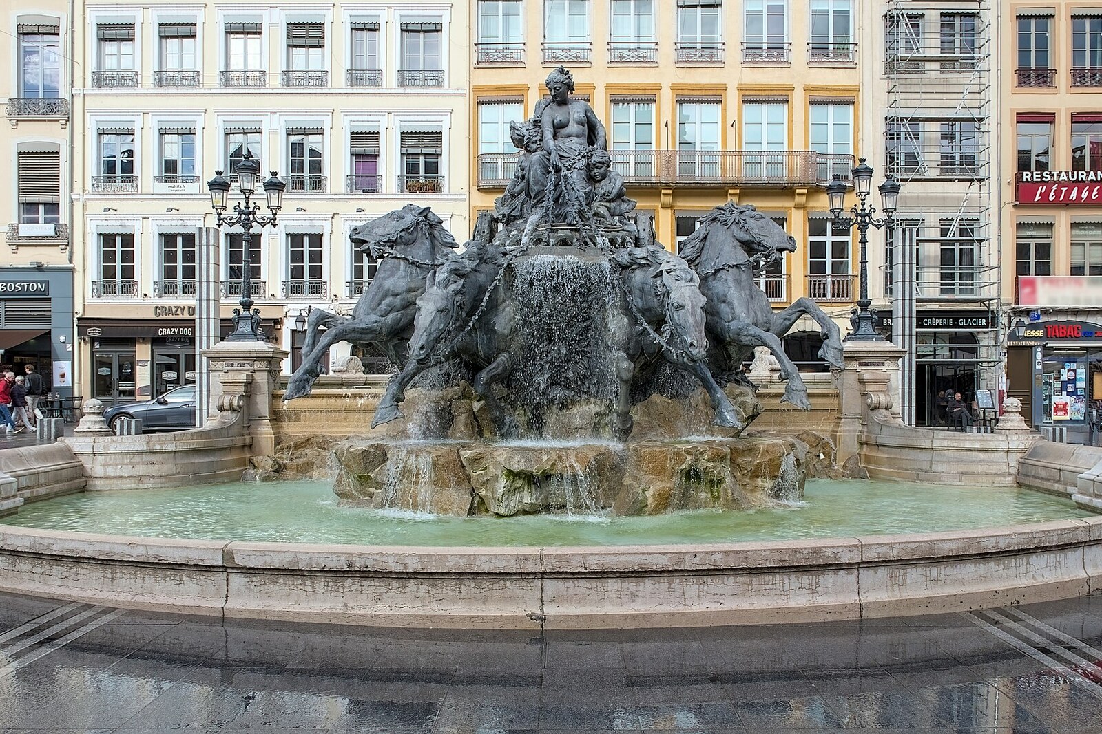 Bartholdi Fountain on Place des Terreaux in Lyon: a female figure in a chariot and four horses on a stone pedestal.