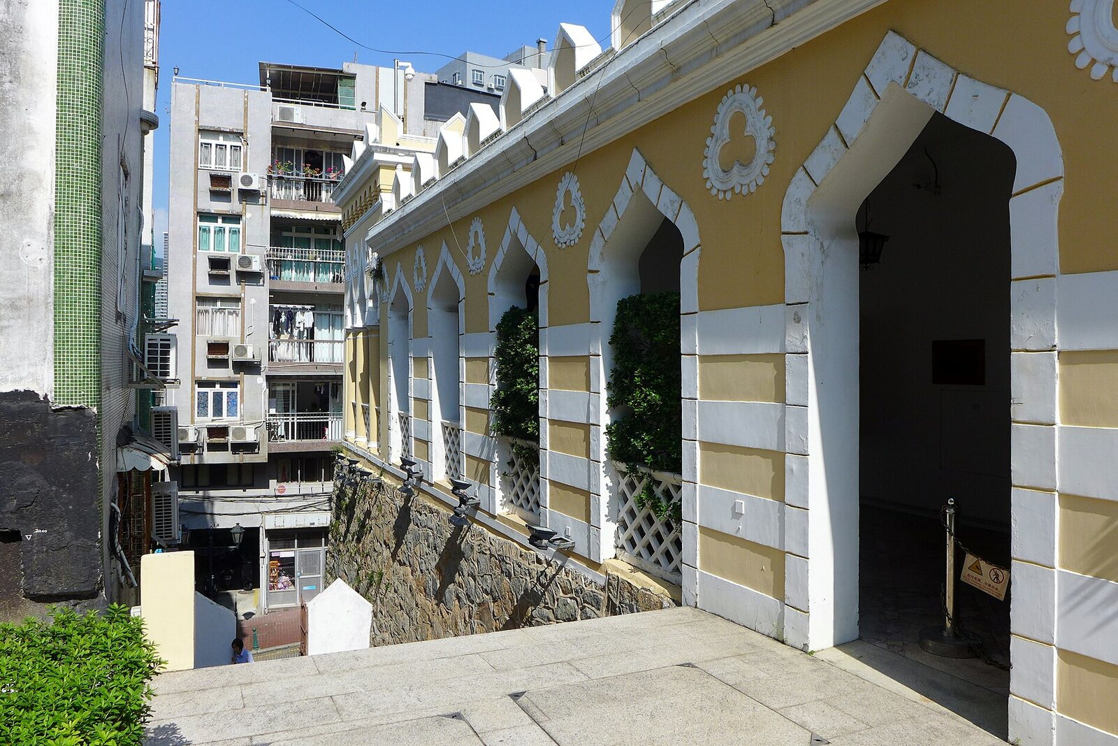 The yellow-and-white facade of the former Moorish Barracks on the slope of Barra Hill.