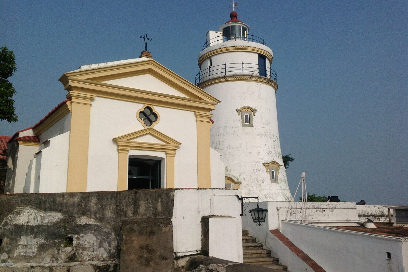A white lighthouse and a small chapel on the summit of Guia Hill