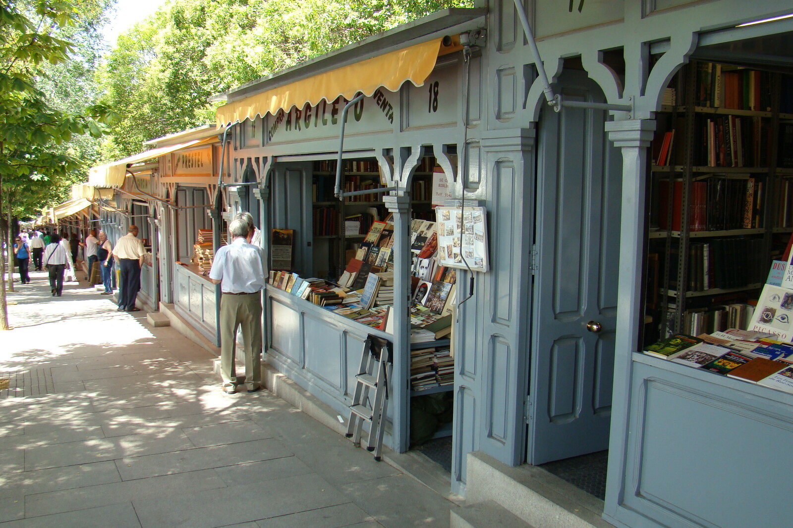 Gray wooden bookstalls on the slope of Cuesta de Moyano in Madrid