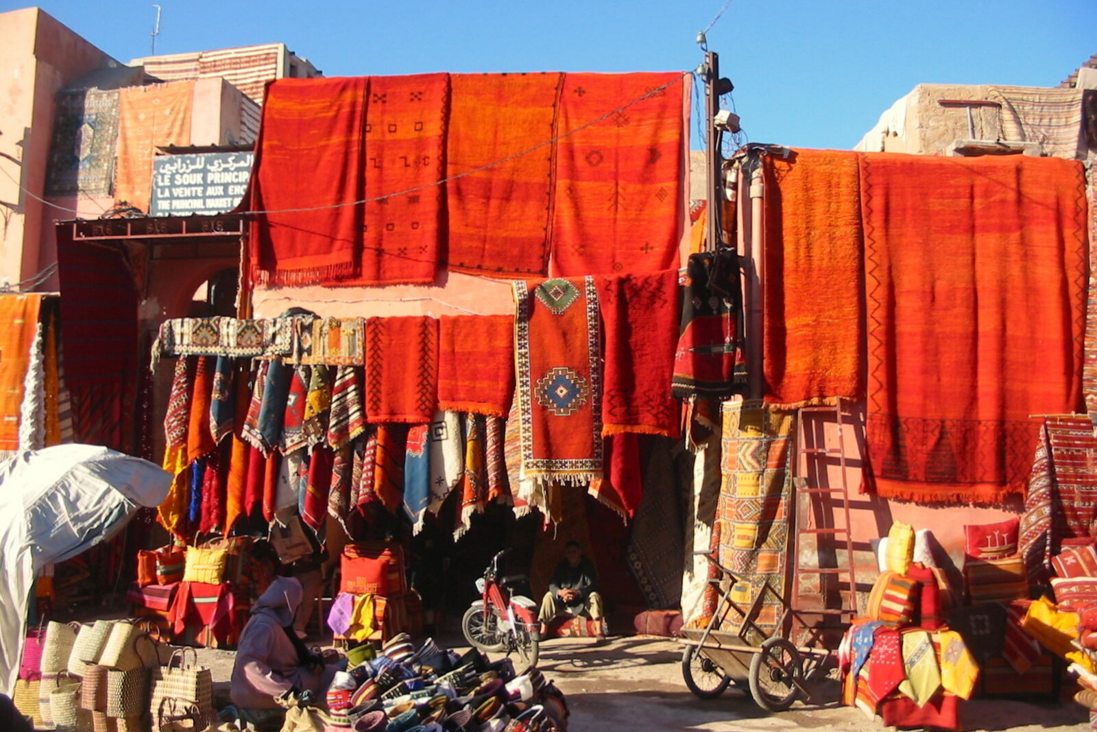 Carpets hanging along a row of shops in Marrakech.