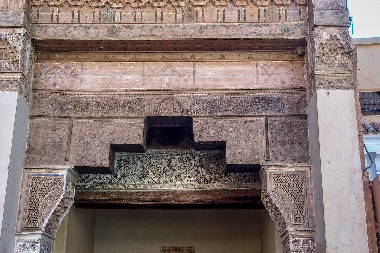 Mouassine Fountain with its street facade, arches, and wooden canopy.