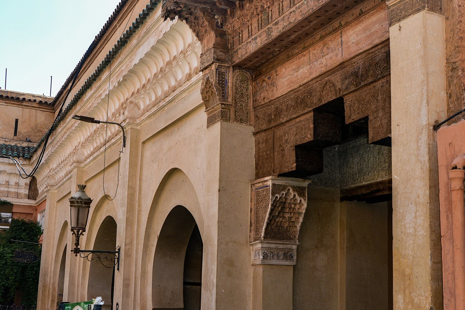 facade of Mouassine Fountain with four arches and a carved wooden canopy