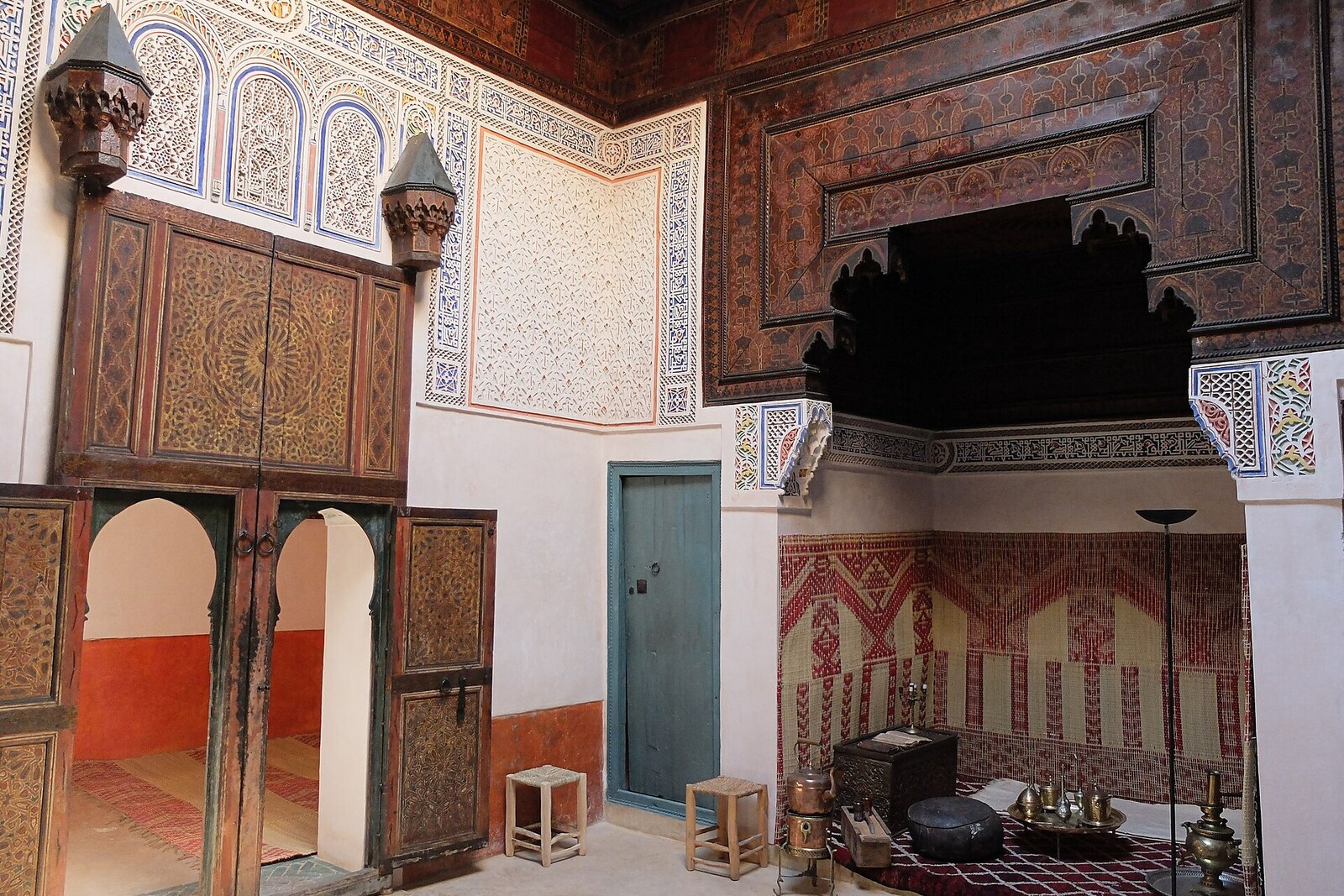 main salon of the Mouassine douiria: painted ceiling, carved plaster, and stained-glass windows