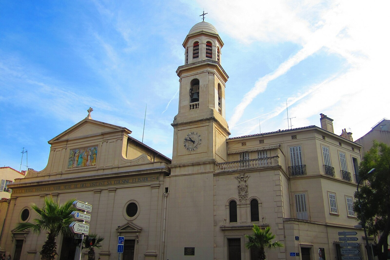 White facade of Notre-Dame-du-Mont Church with steps and columns