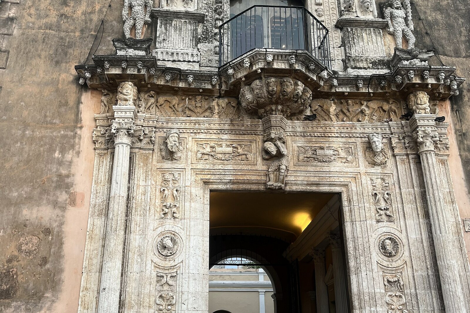 The carved portal of Casa de Montejo, with a coat of arms and figures in armor.