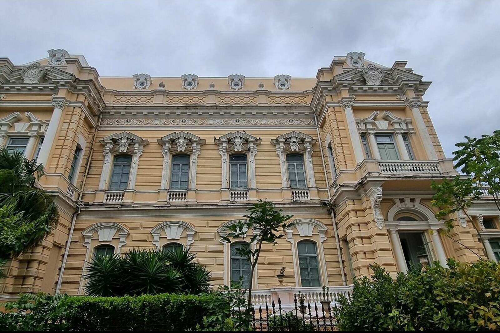 The corner façade of Palacio Cantón with its dome and balconies.