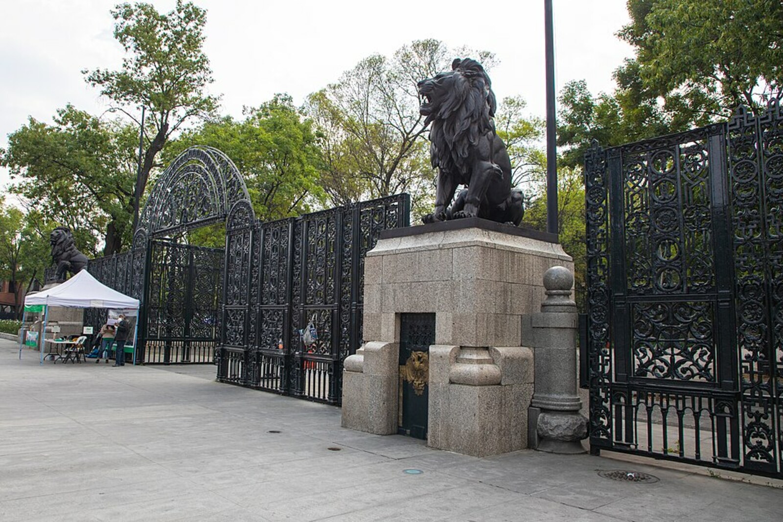 Chapultepec's main gate with bronze lions on pedestals.