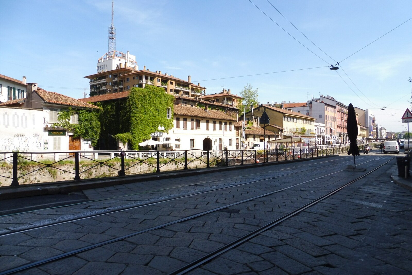 Naviglio Grande with houses and lights along the Ripa di Porta Ticinese waterfront in the evening