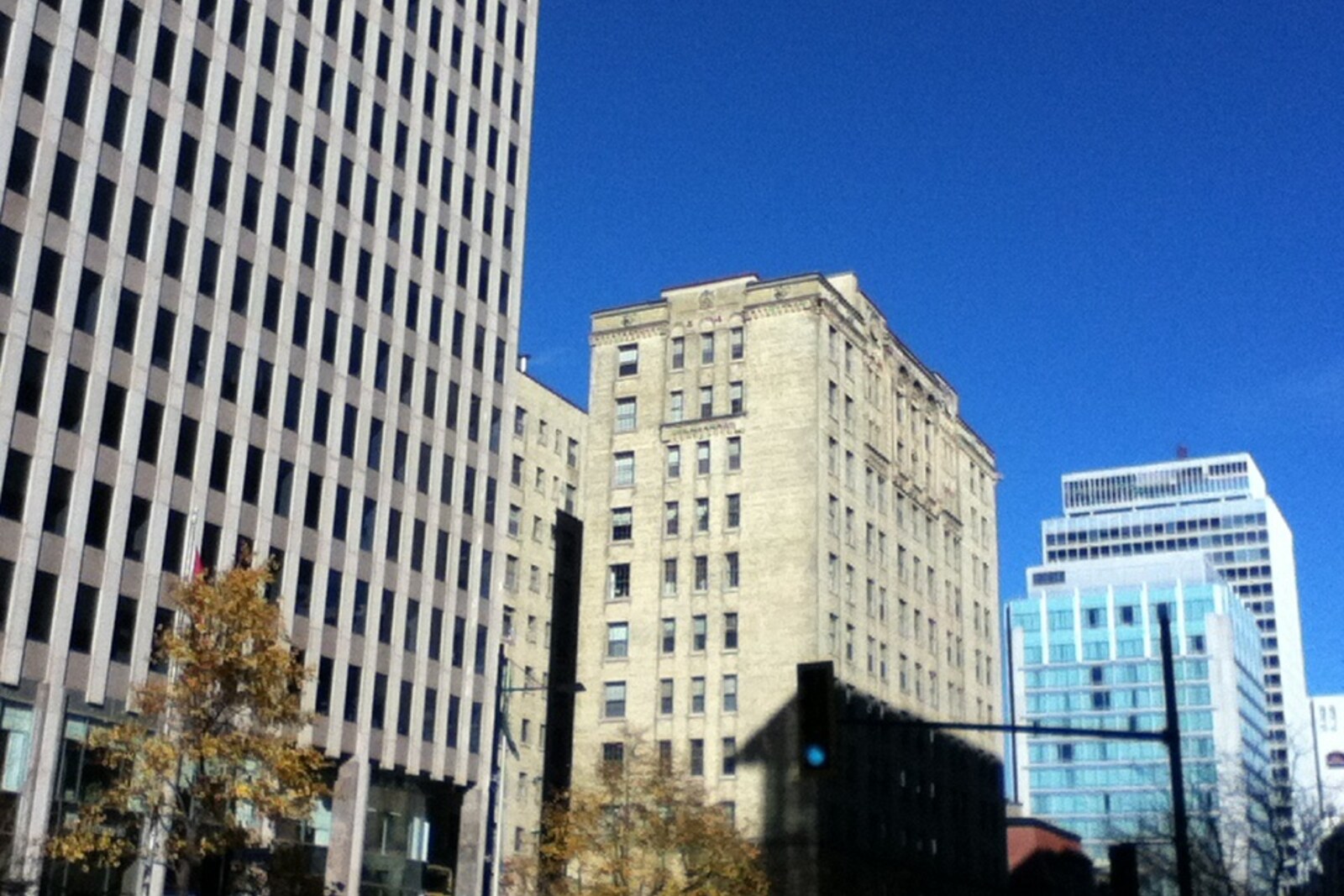 Sherbrooke Street in Montreal, with rows of buildings and trees on both sides.