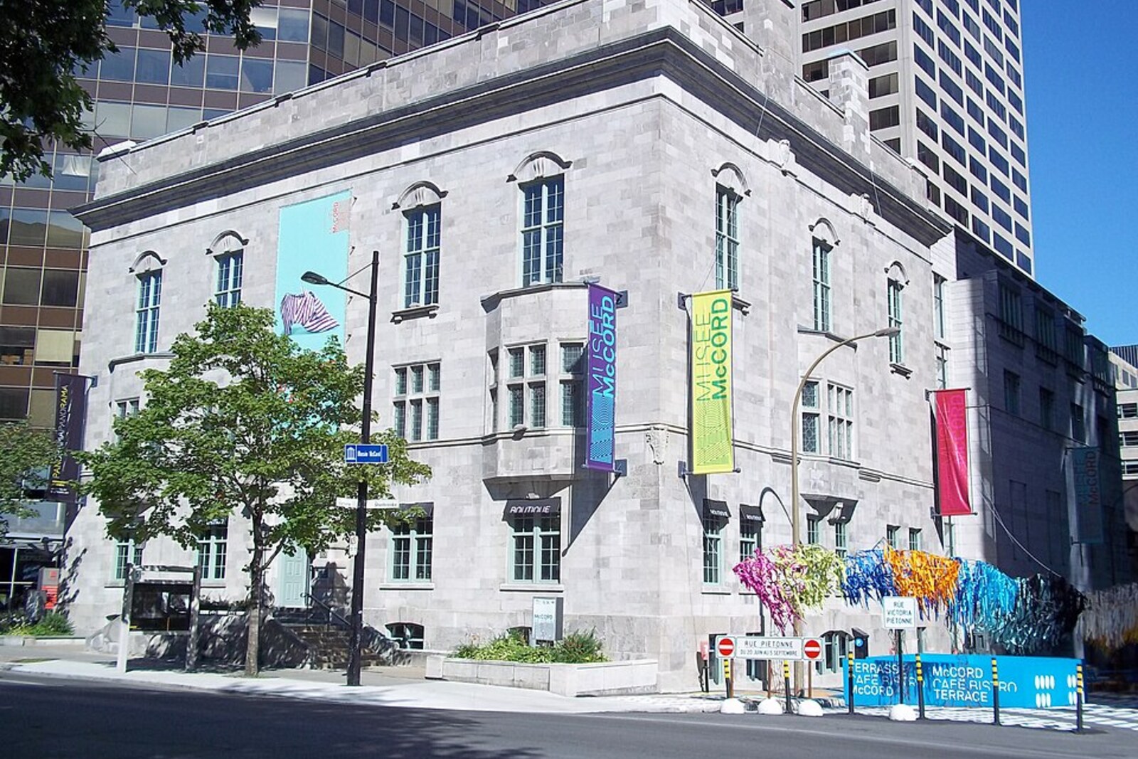 Stone facade of the McCord Stewart Museum with a staircase and carved decorations.