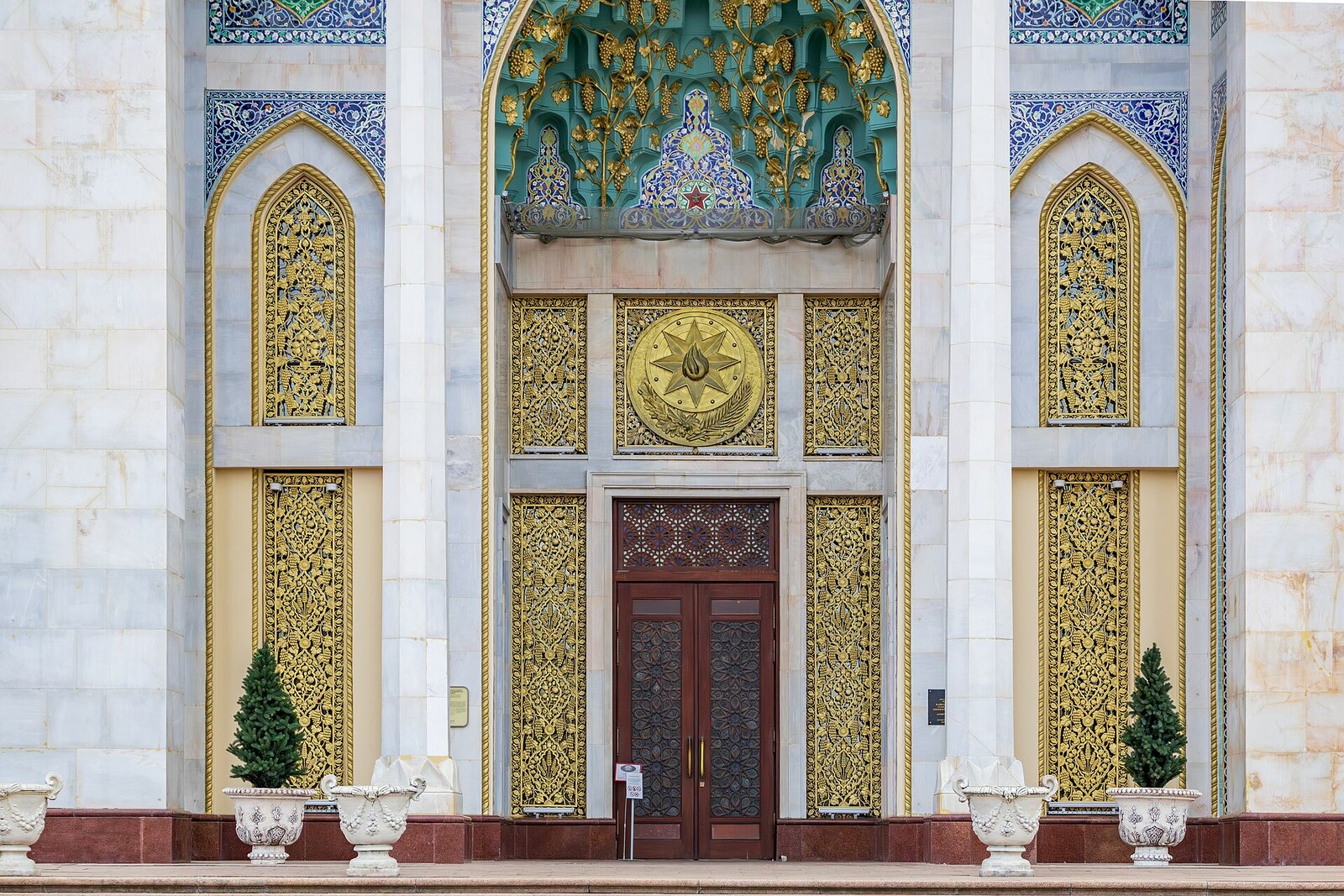 The pointed portal of the Azerbaijan Pavilion, with blue majolica, golden vines, and carved latticework.