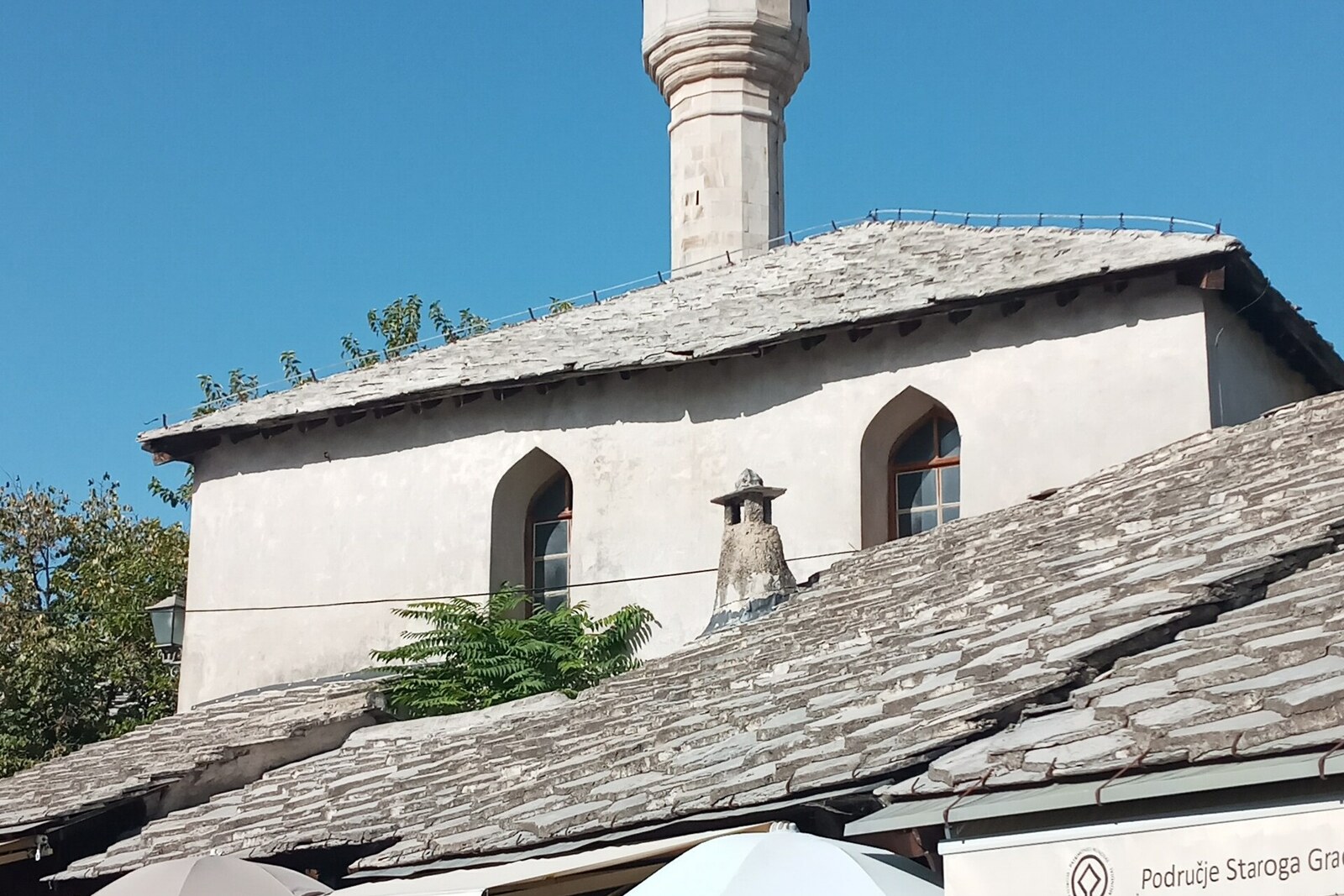 Tabačica Mosque with a slate roof and a slender white minaret.