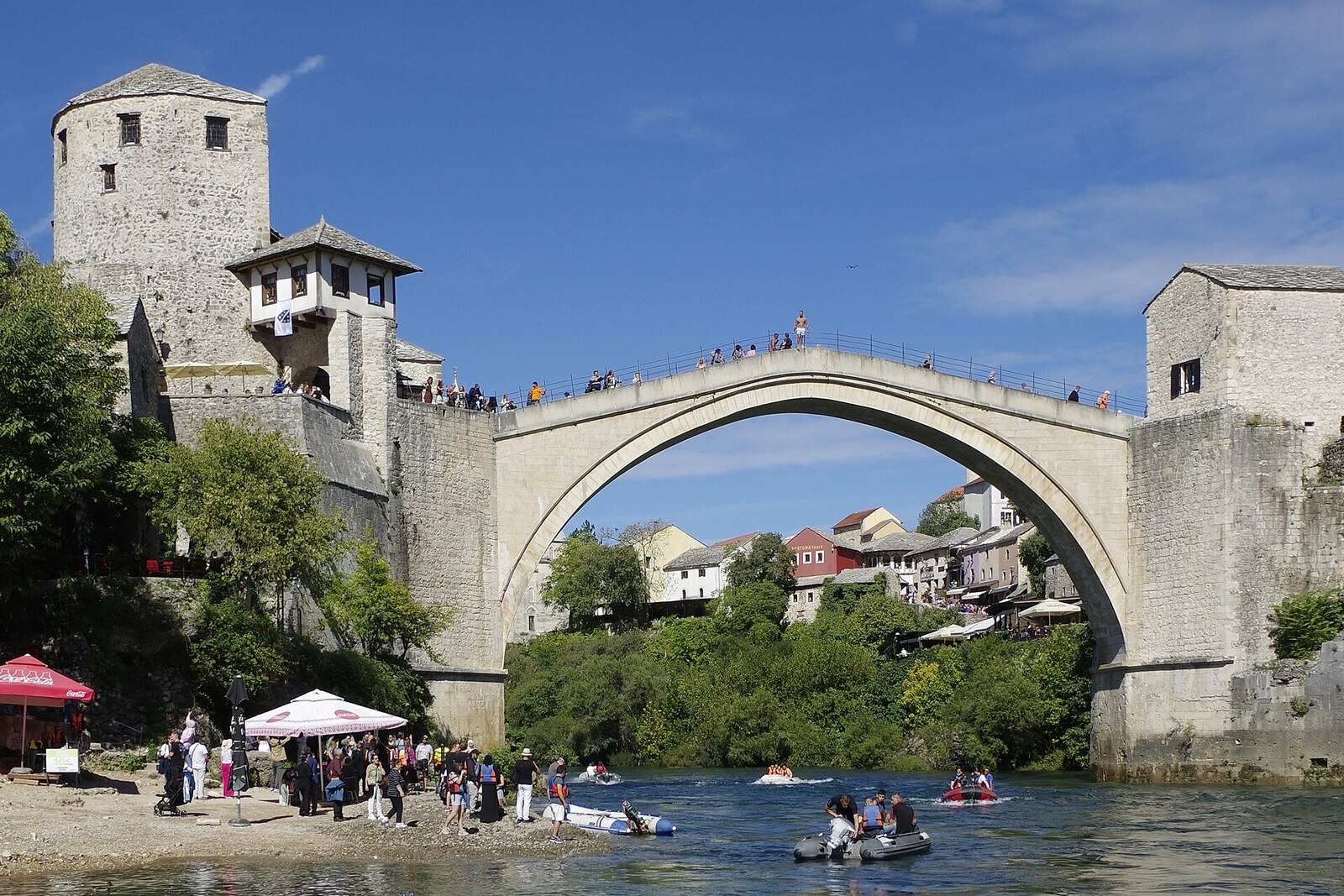 Seen from below are the stone arch of the Old Bridge and its supports above the Neretva.