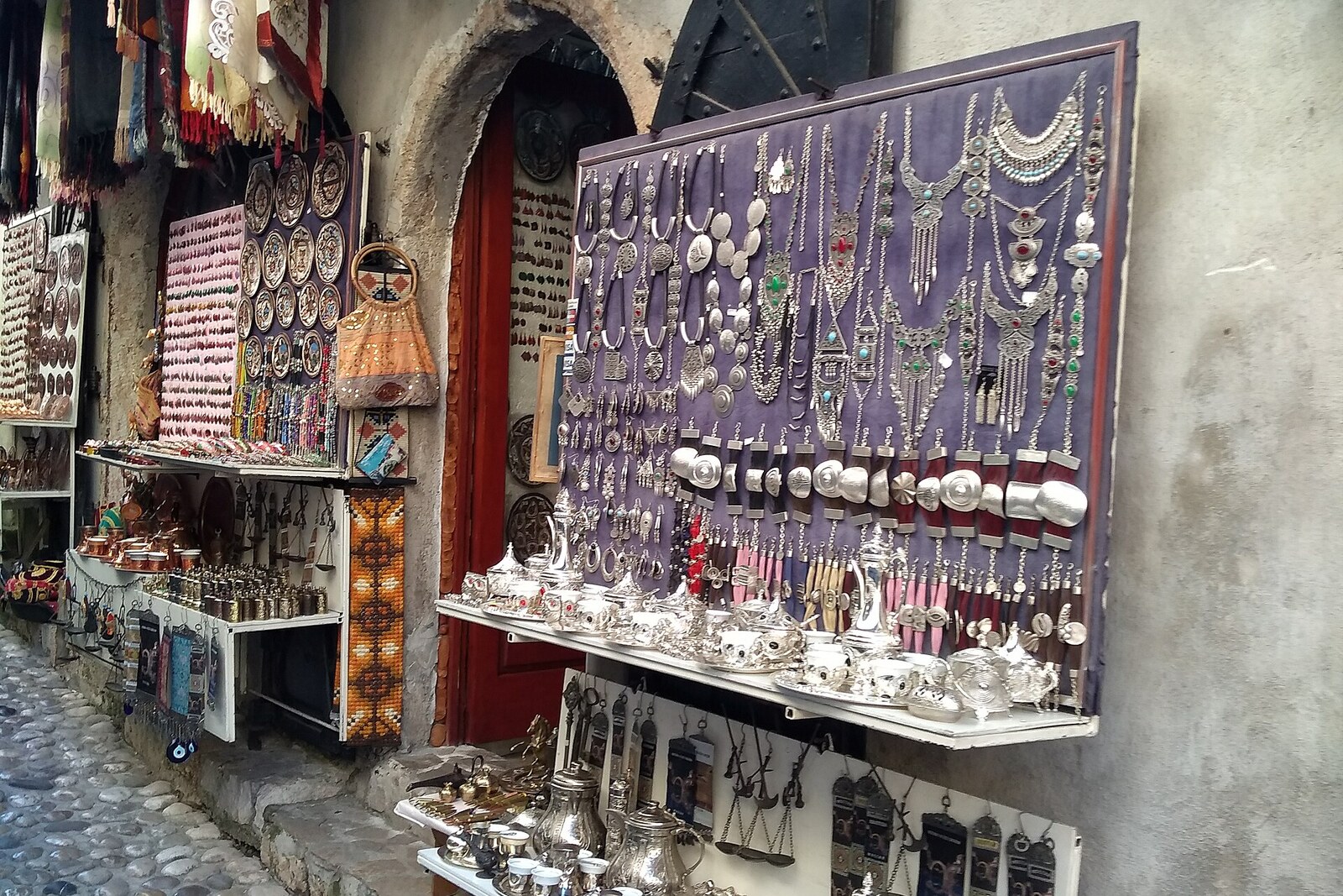 The stone street of Kujundžiluk runs between closely packed rows of shops.