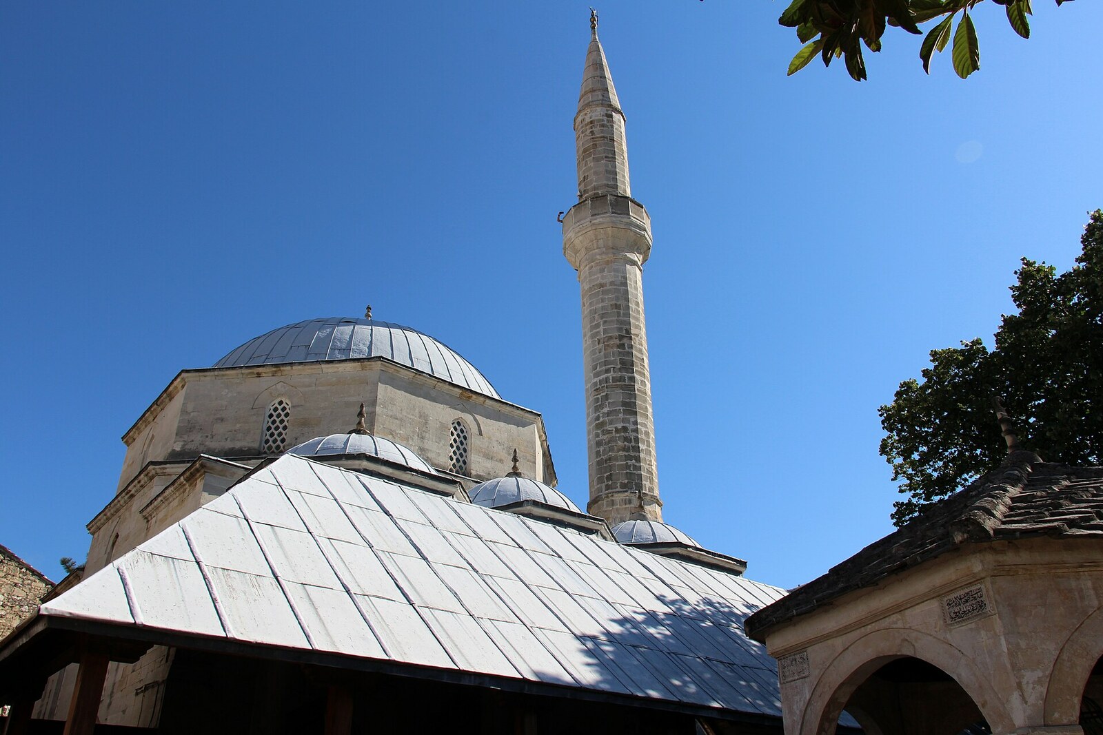 The dome and minaret of Koski Mehmed Pasha Mosque above the roofs of old Mostar.