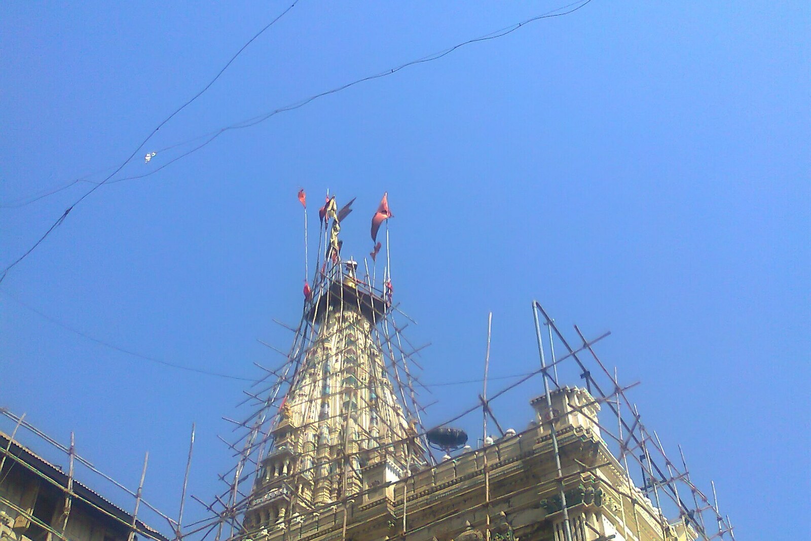 The shikhara of Mumba Devi Temple amid the dense development of Bhuleshwar in Mumbai.