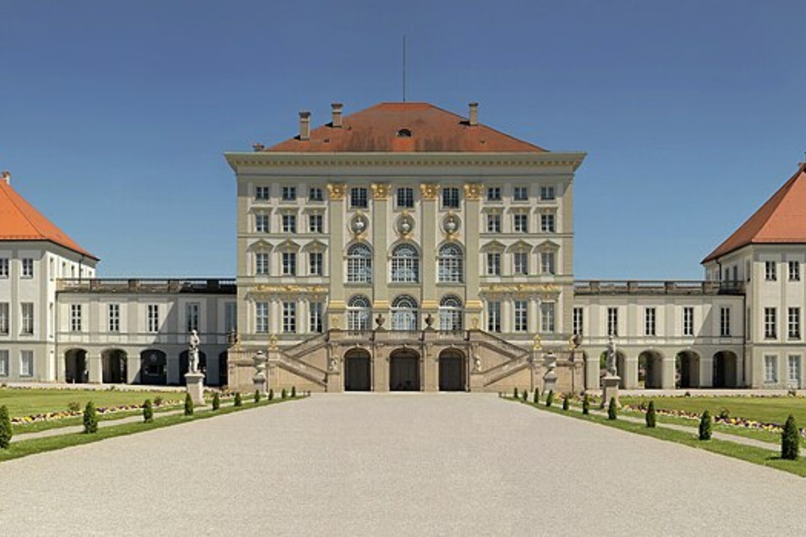 The façade of Nymphenburg Palace and the parterre on a sunny day.