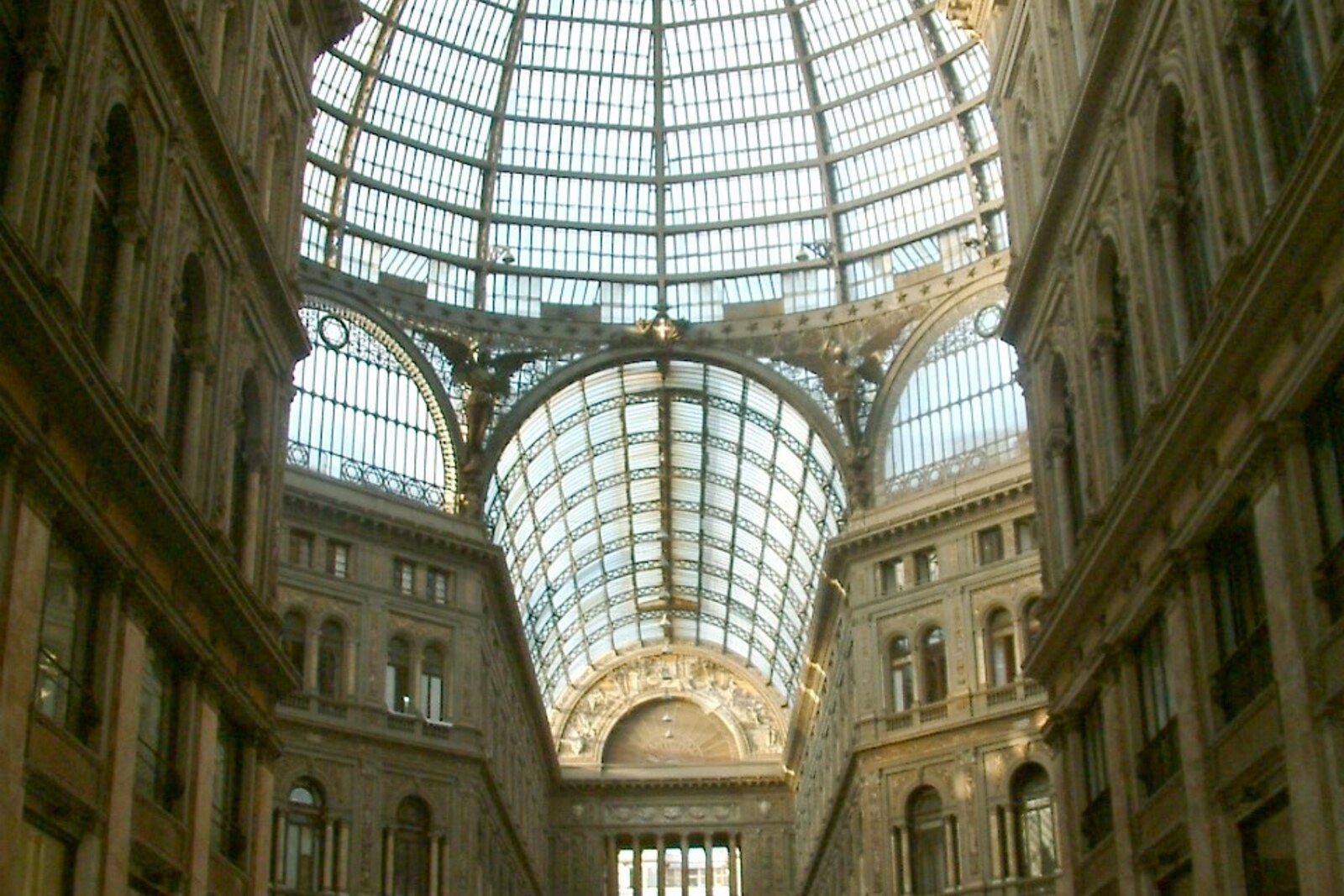 Interior of Galleria Umberto I in Naples, with tall arches and a glass dome