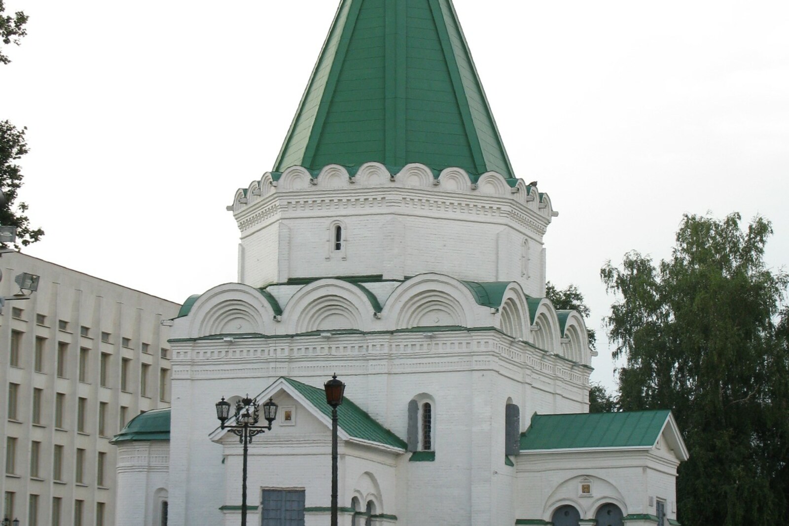 The white Archangel Michael Cathedral with a tall green tent roof