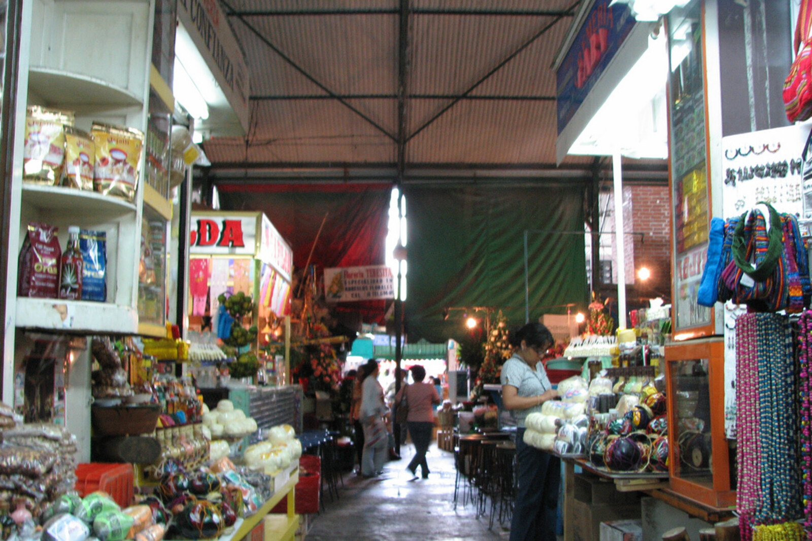 Inside Mercado Benito Juárez: narrow aisles with stalls and high iron arches
