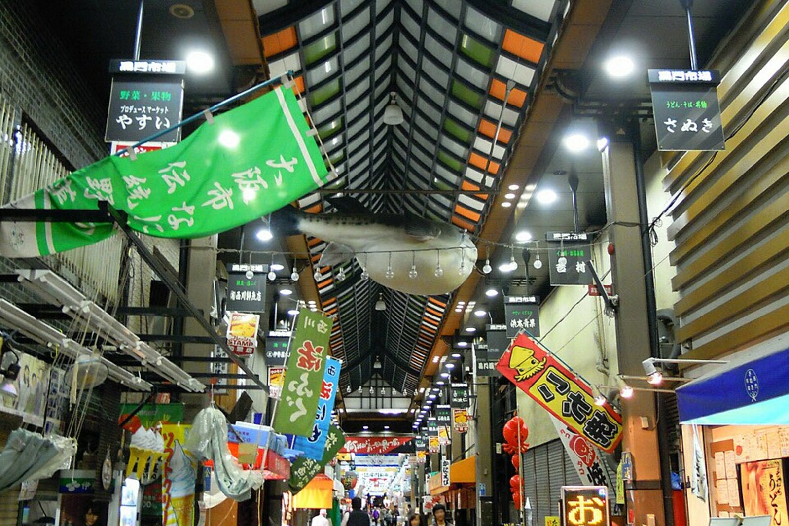 Kuromon Market: covered rows and people at the counters