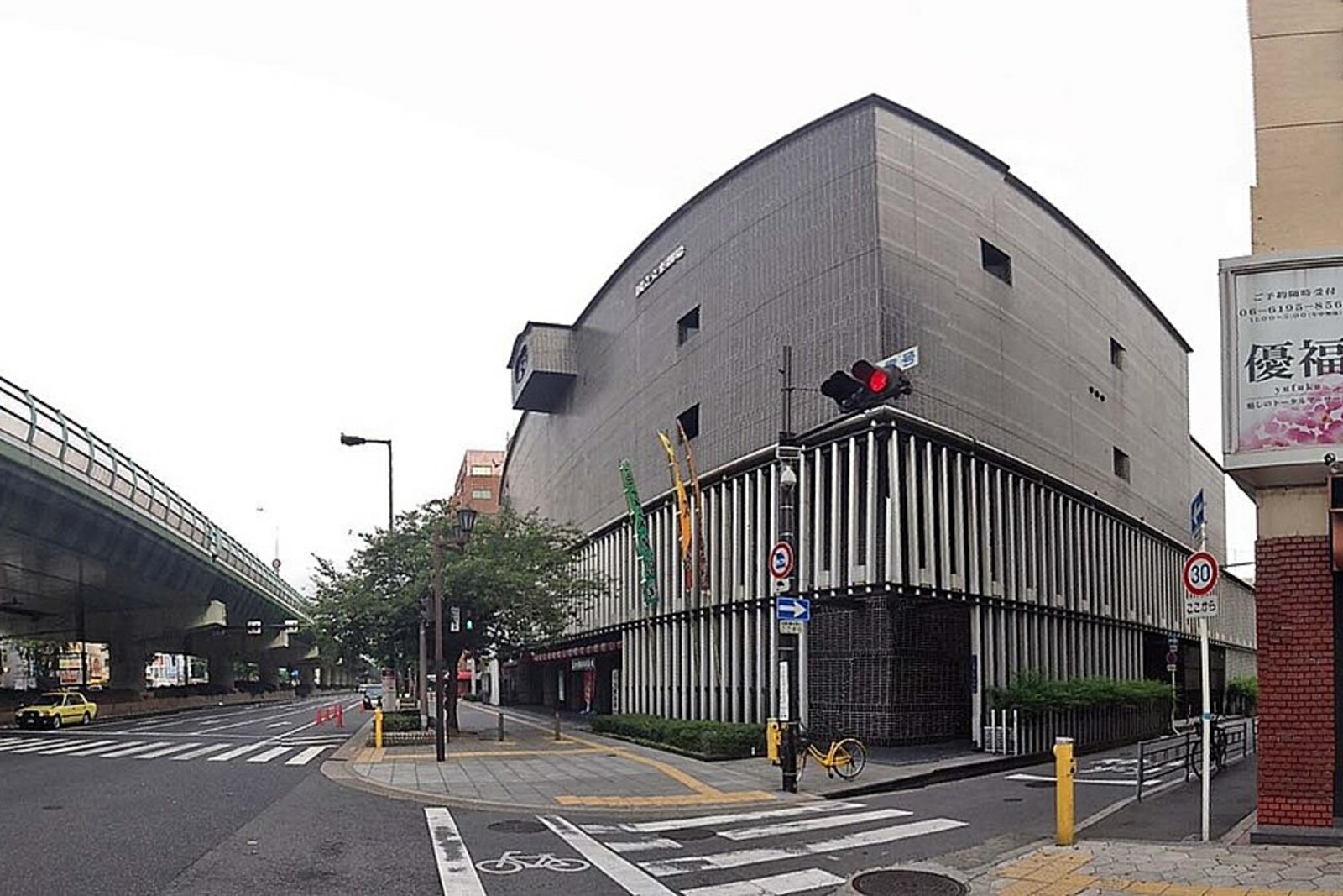 Modern National Bunraku Theatre building with signs