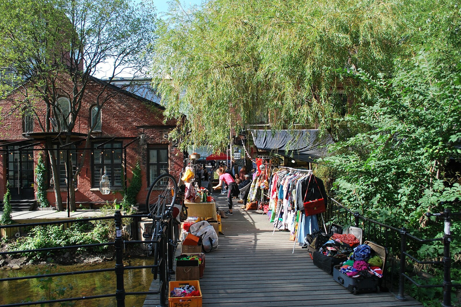 Sunday market by the Blå bar in Oslo, with people, a bridge, and graffiti