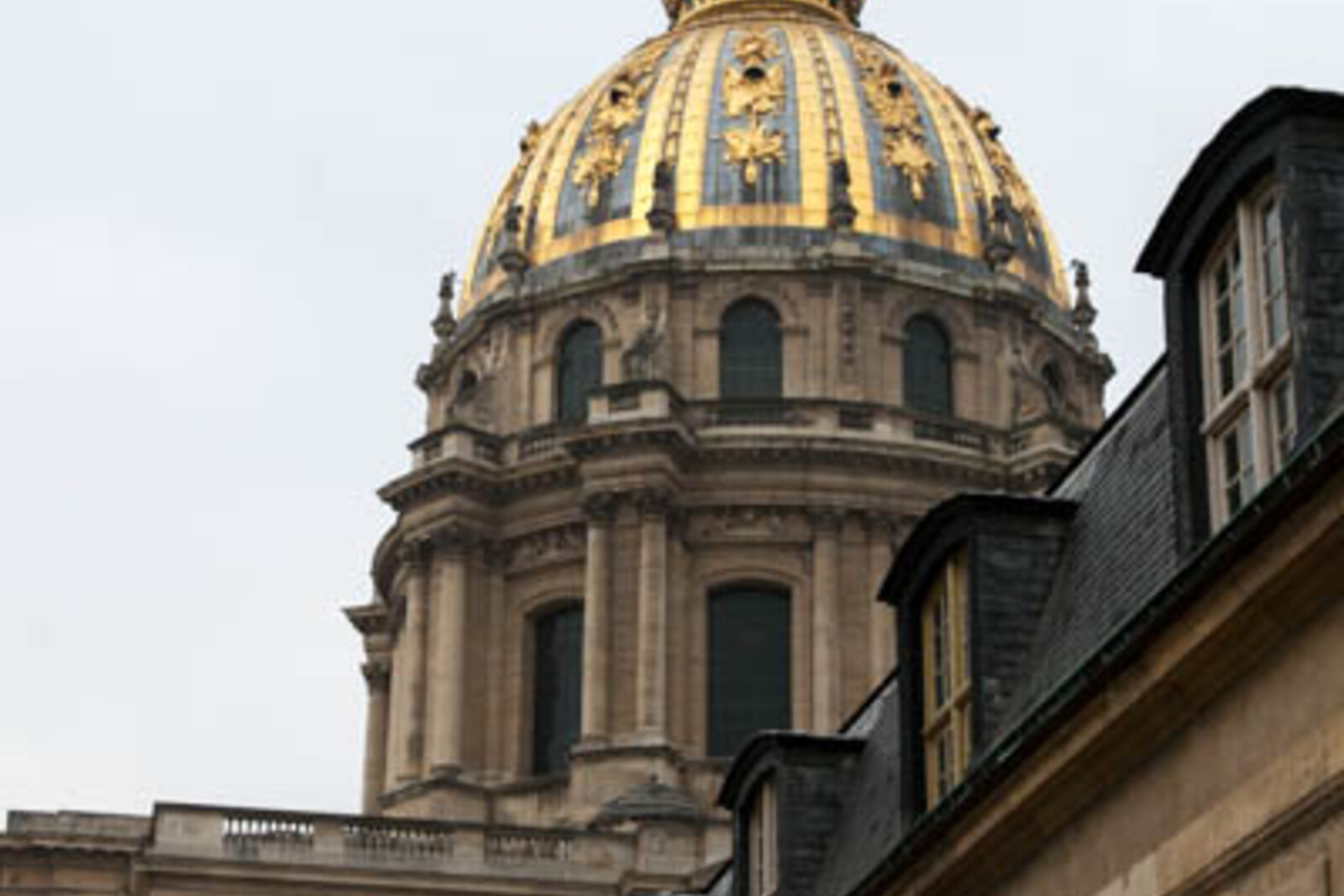 The first view of the golden Dôme des Invalides along a green vista.