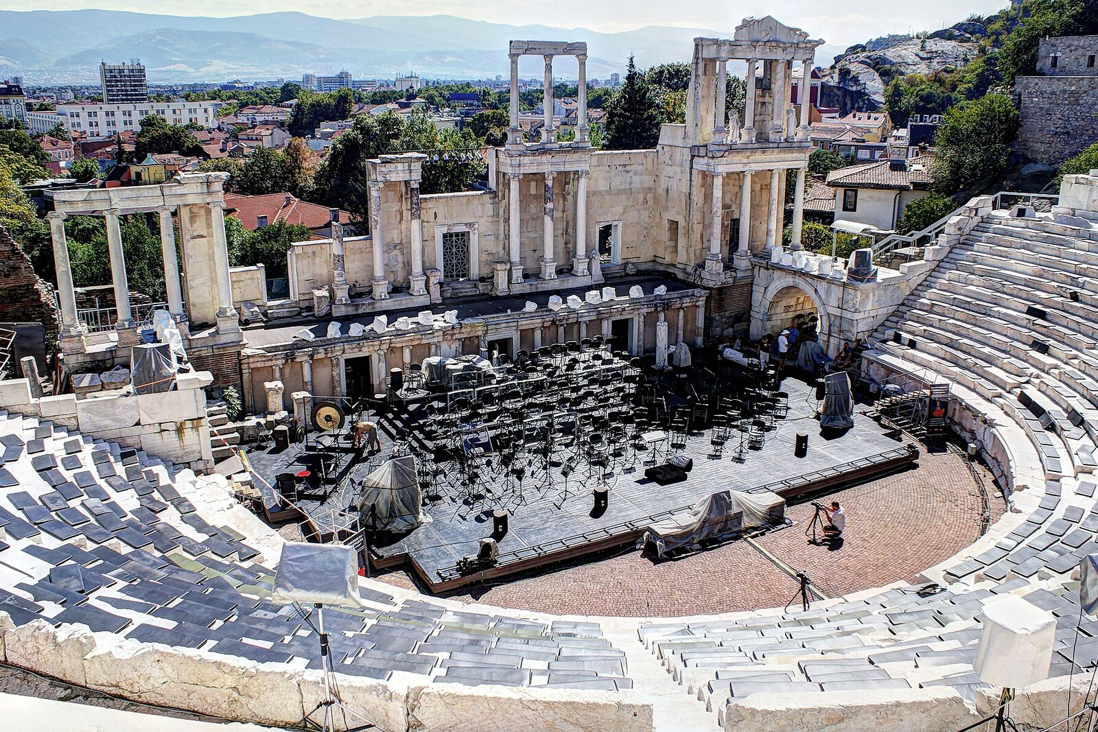 Ancient Theatre of Plovdiv with semicircular rows, the colonnaded facade of the stage, and concert equipment