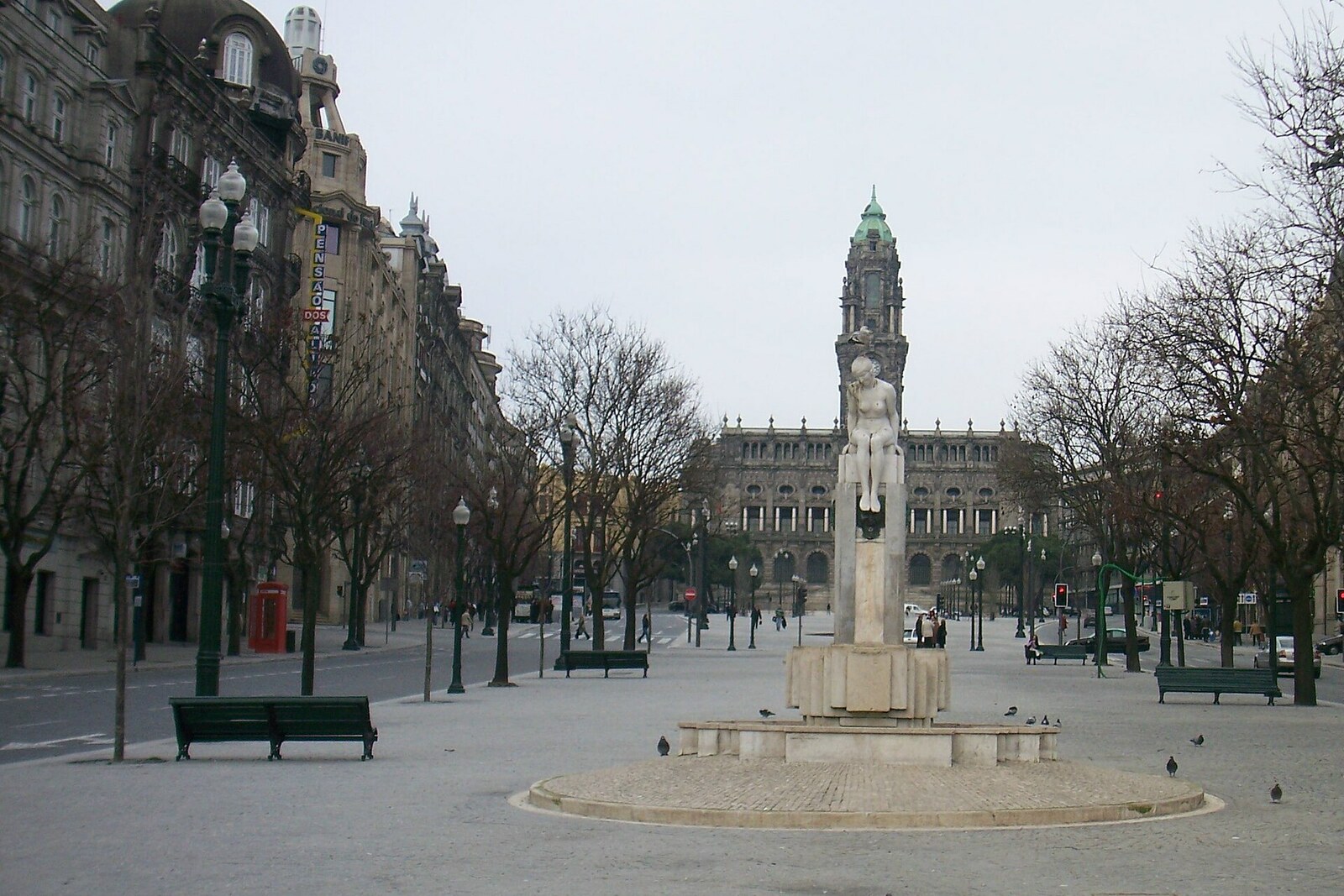 Avenida dos Aliados: a granite avenue with green trees and the city hall tower on the horizon.