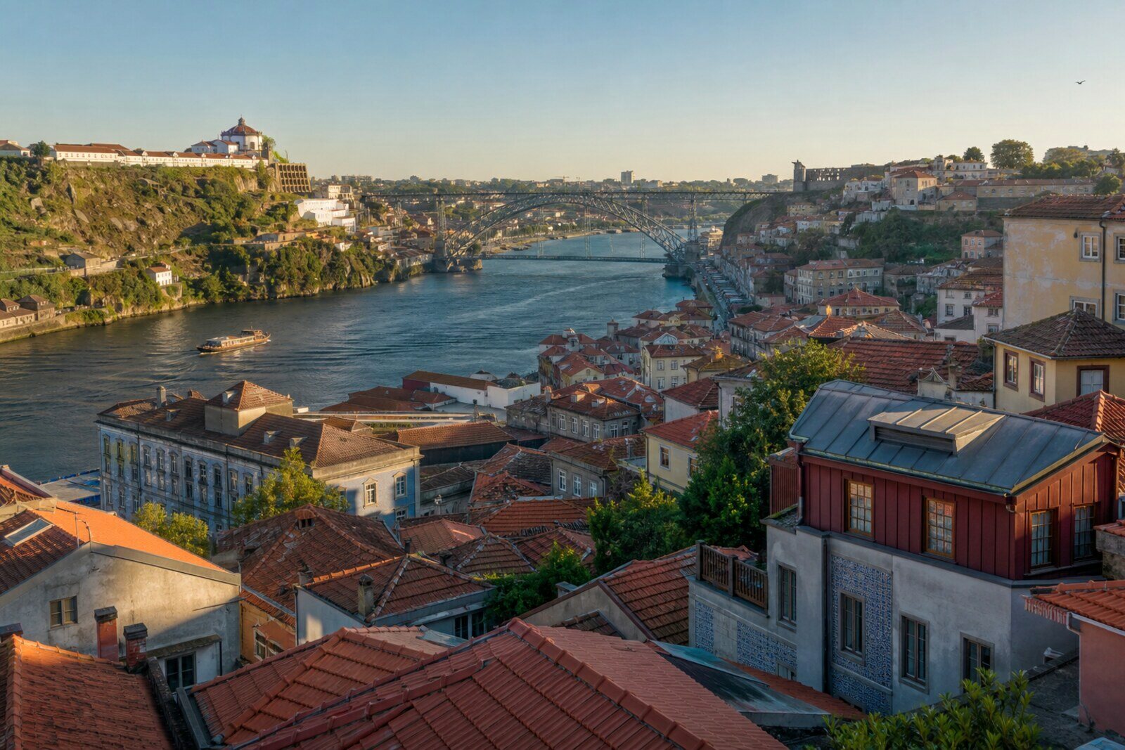 A panoramic view of Porto from top to bottom: from the Porto Cathedral hill, through rooftops and Clérigos Tower, to the Douro and Dom Luís I Bridge.