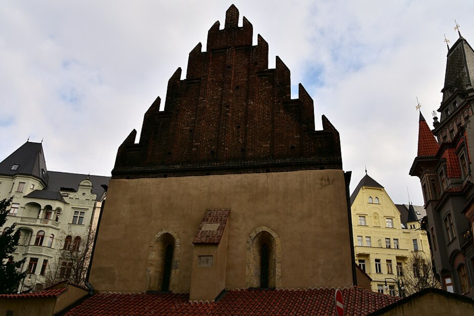 The Old-New Synagogue in Prague with a Gothic façade and a red-tiled roof.