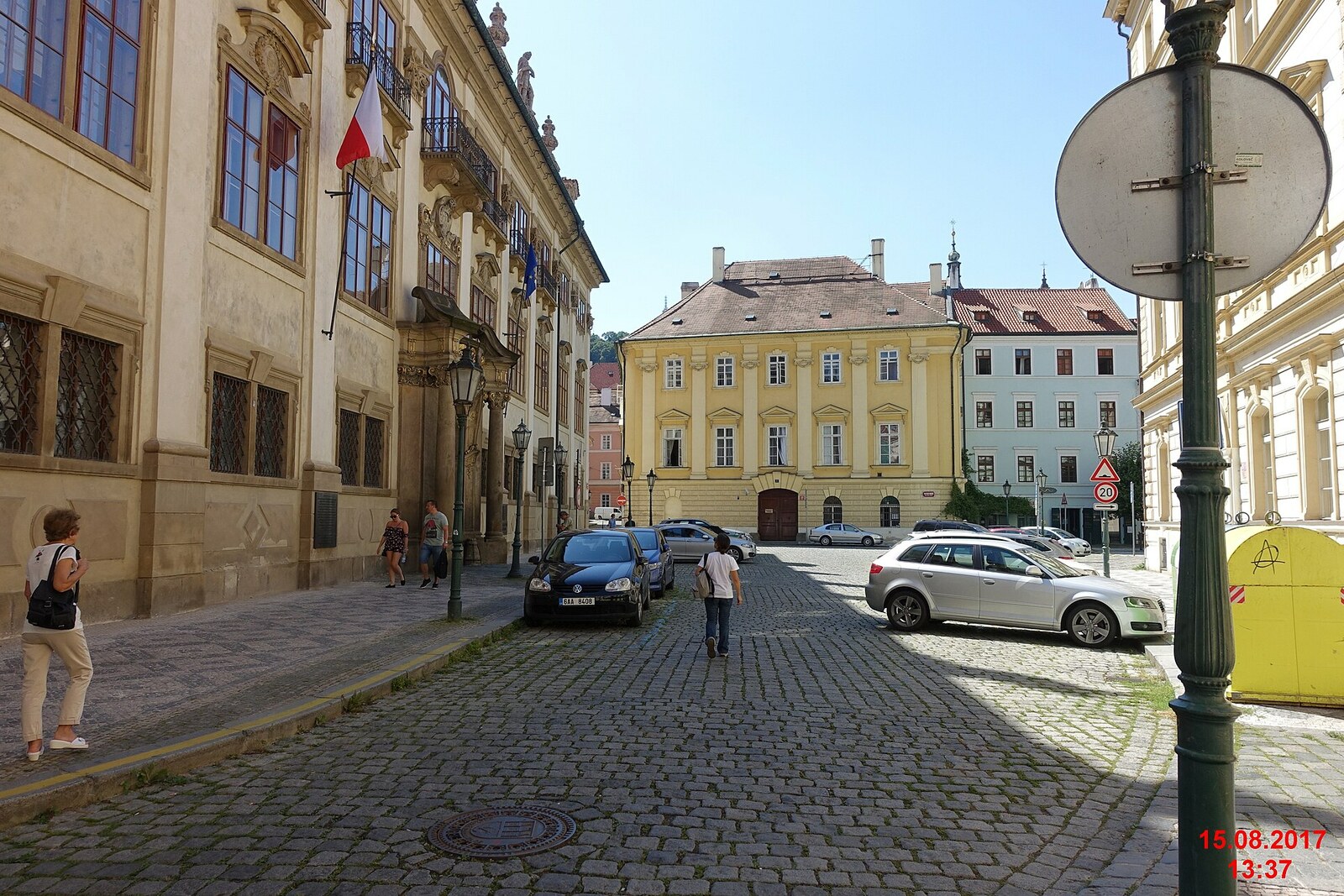 Maltese Square in Prague with historic façades and a church fence.