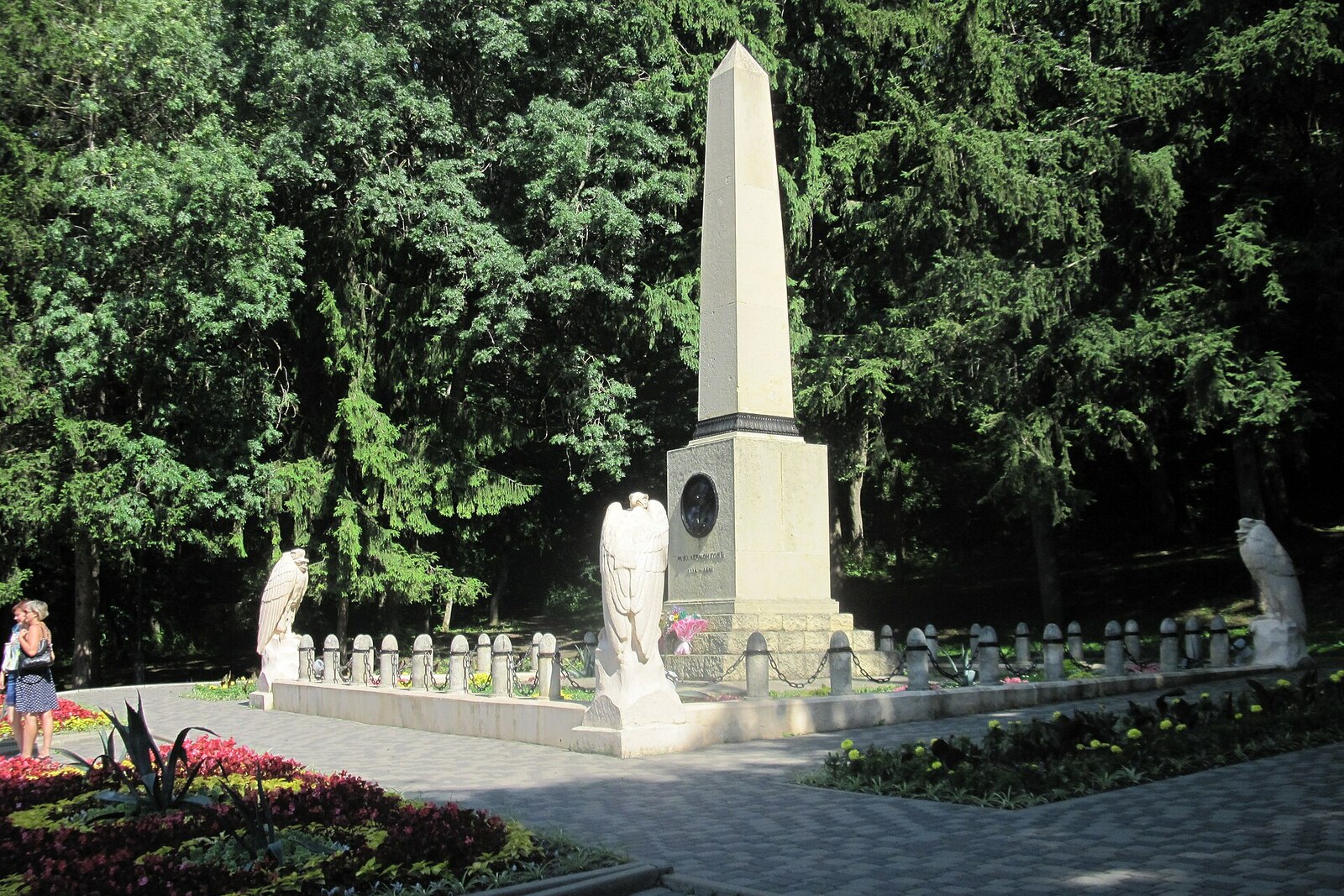 The stone obelisk at Lermontov’s duel site behind a circular fence among trees.