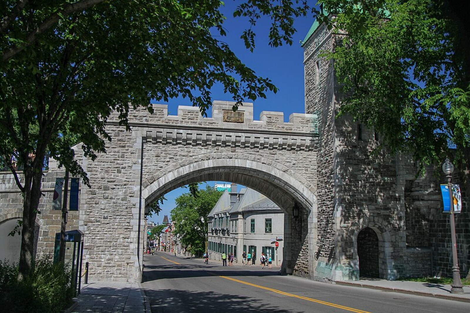 The stone Saint-Louis Gate and a street leading toward a castle