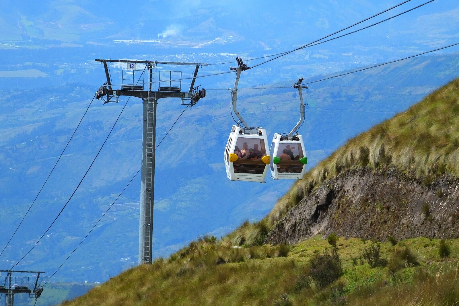 Cable-car cabins against the slopes of Pichincha.