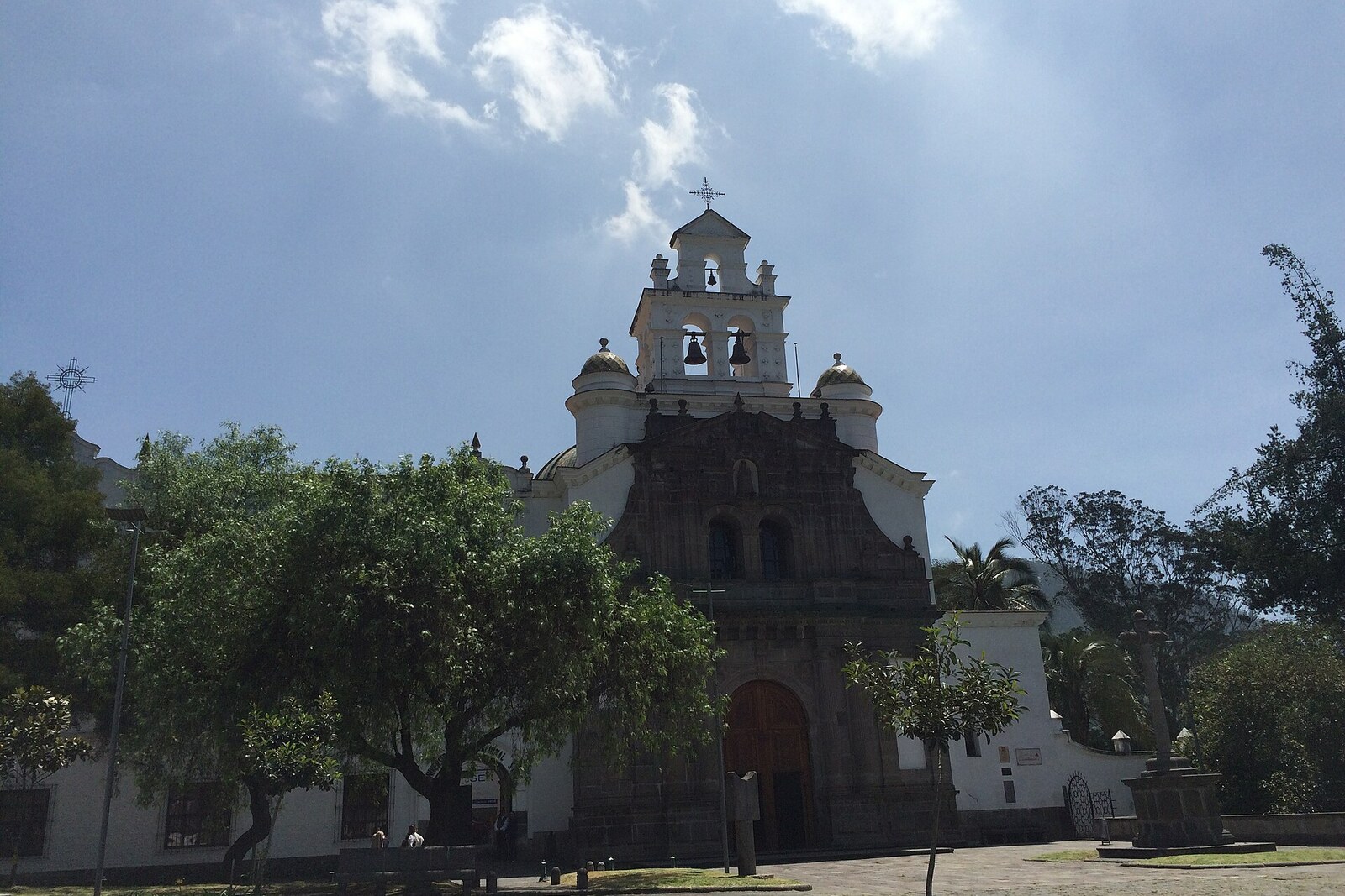 Mountain slope with a colonial church and Guápulo Monastery amid greenery
