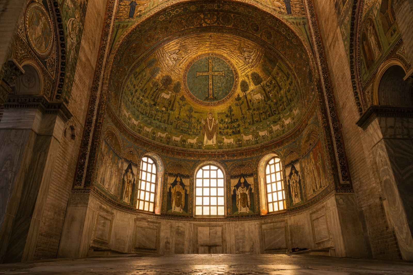 Abstract cover with gold and blue Ravenna mosaic motifs, an octagonal plan, and the silhouette of a brick basilica.