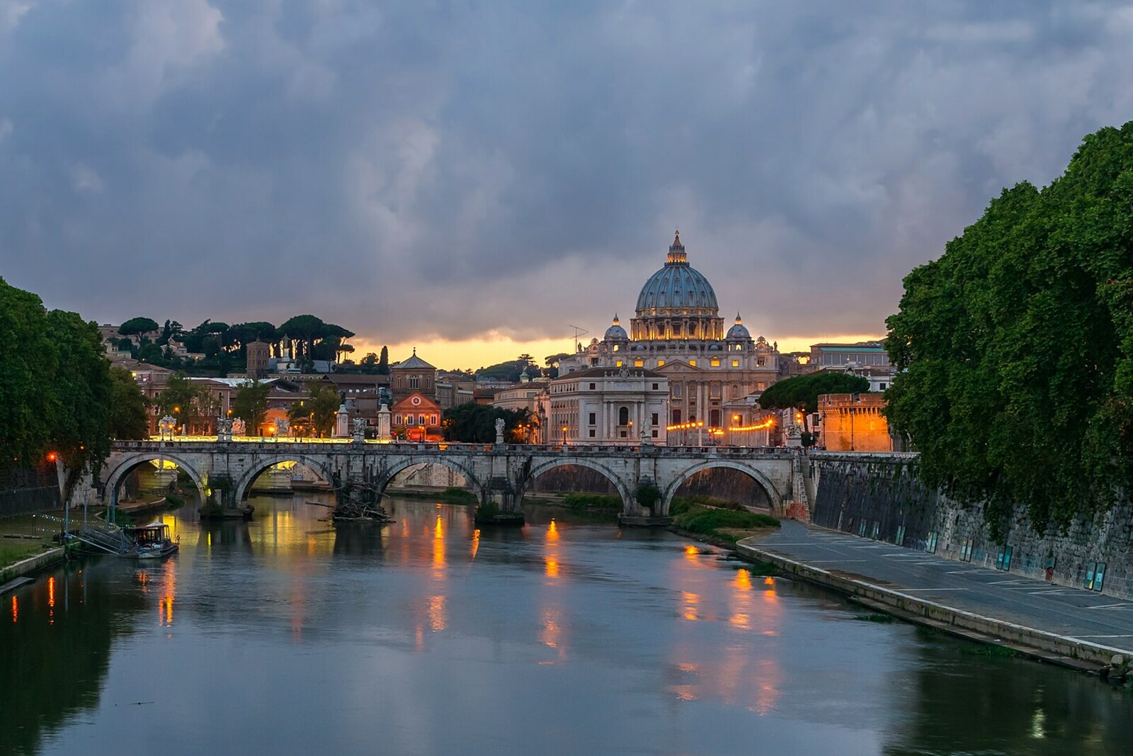 Sunset over Ponte Sant'Angelo with a view of the dome of St Peter's Basilica.