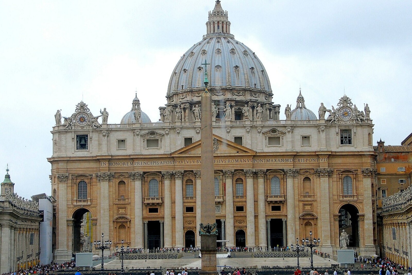 The facade of St Peter's Basilica with its dome and an obelisk in the foreground.