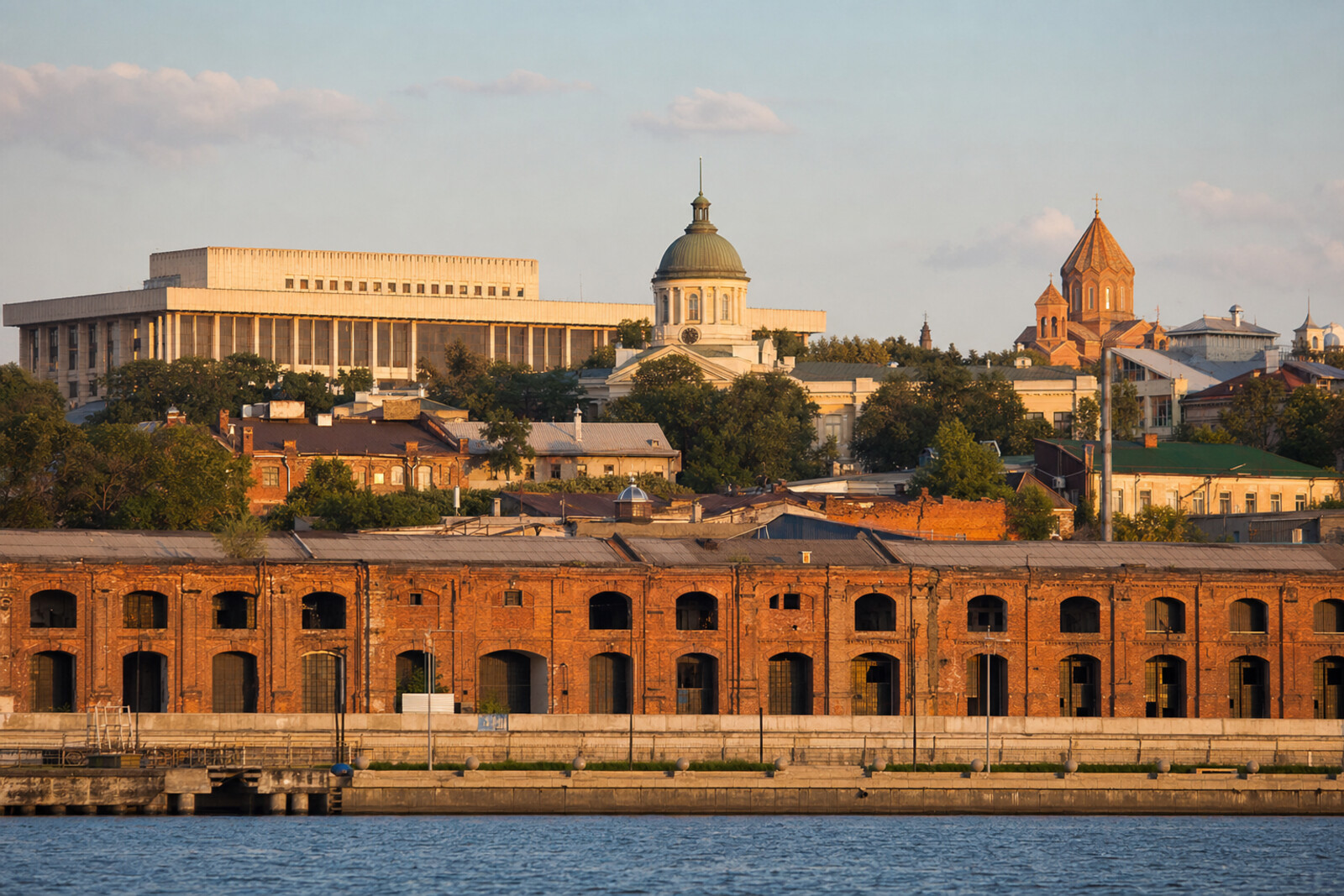Illustrated panorama of Rostov-on-Don: the Don River, brick warehouses, the dome of Rostov City Duma, a theatre, and an Armenian church.