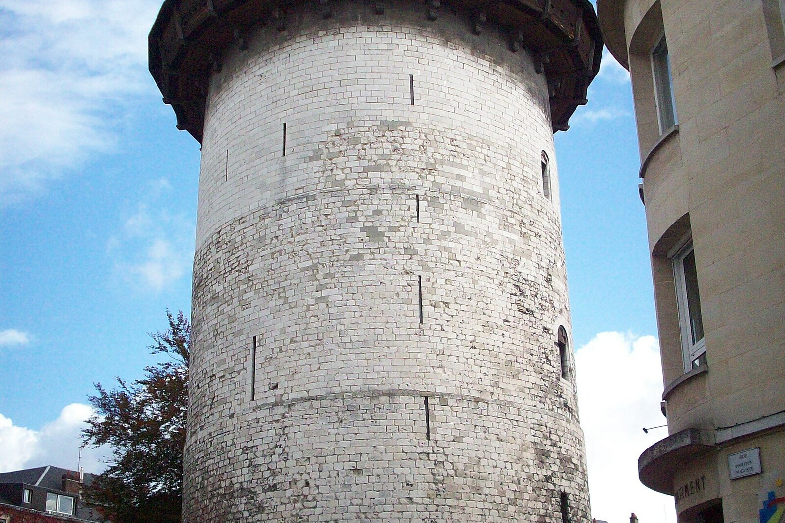 Joan of Arc Tower, with a round stone tower and a conical roof.