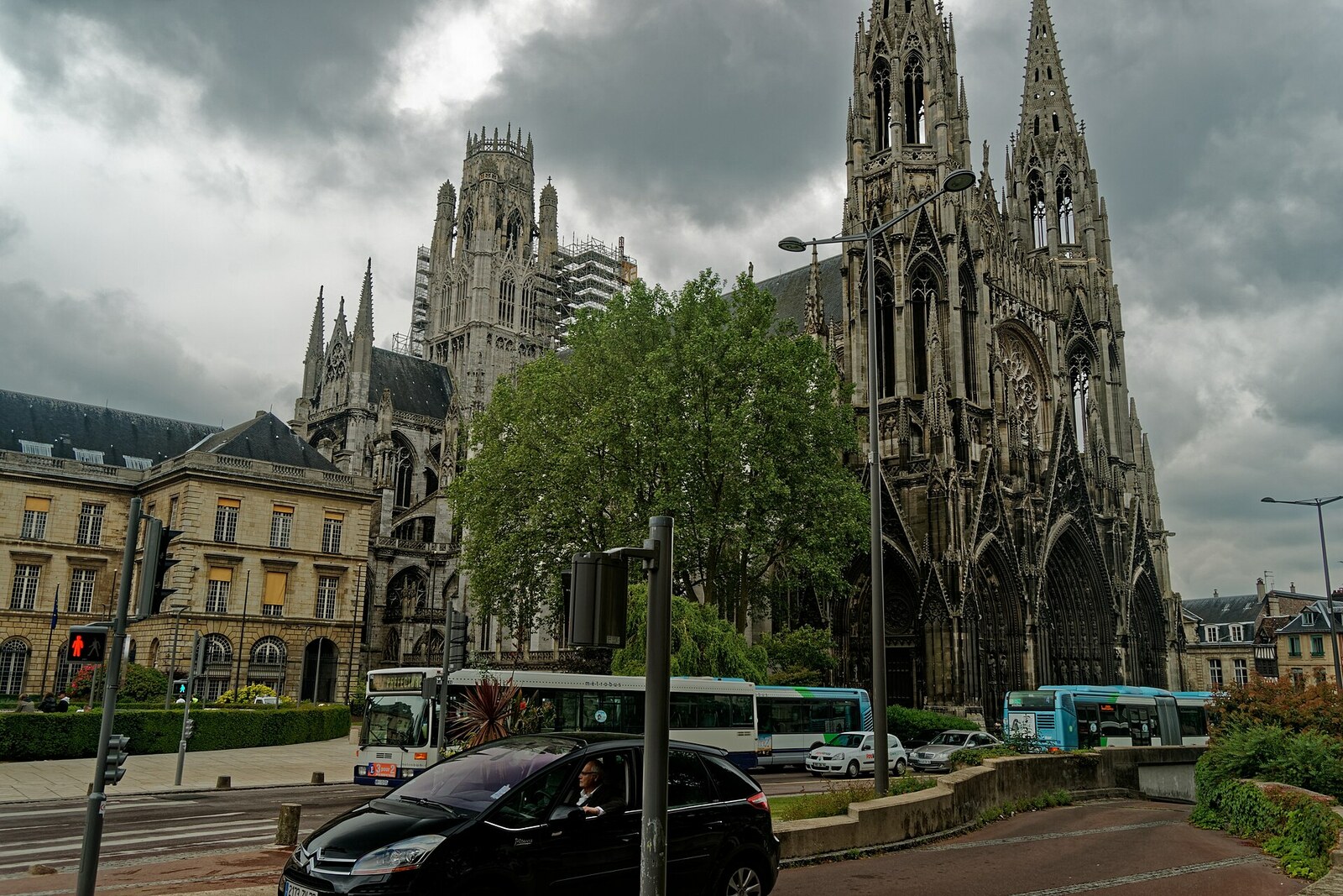 The tall Gothic façade and towers of Saint-Ouen Abbey Church in Rouen.