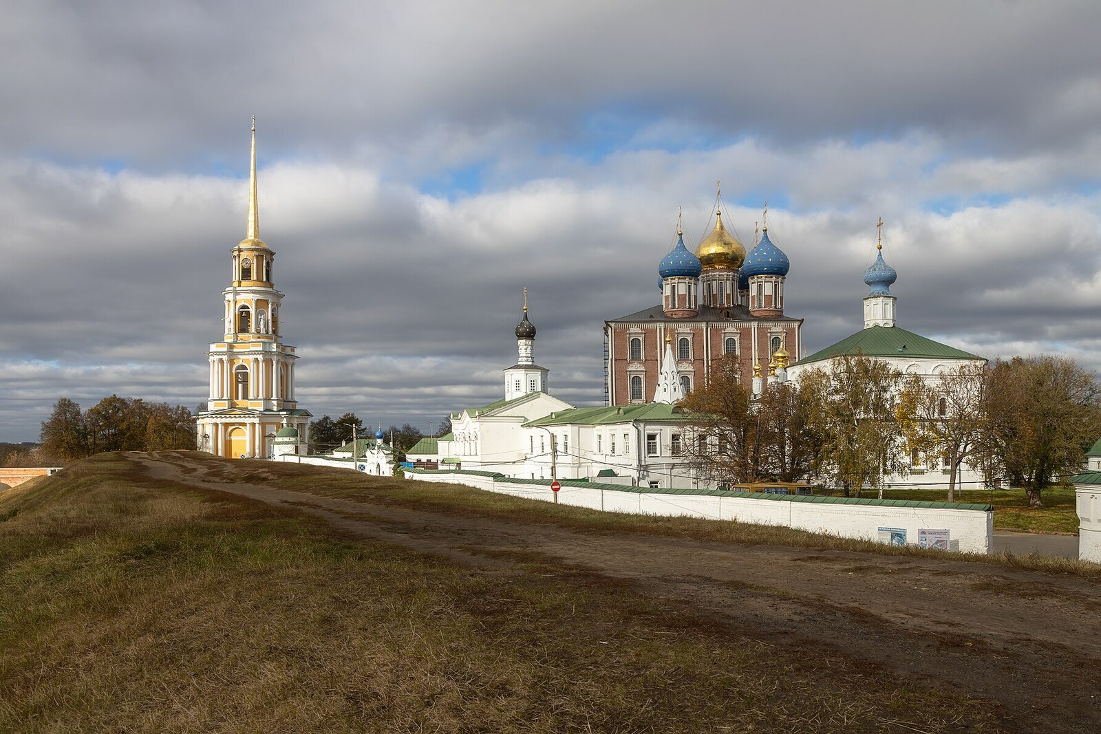 An earthen rampart in the foreground and the cathedrals of the Ryazan Kremlin beyond it