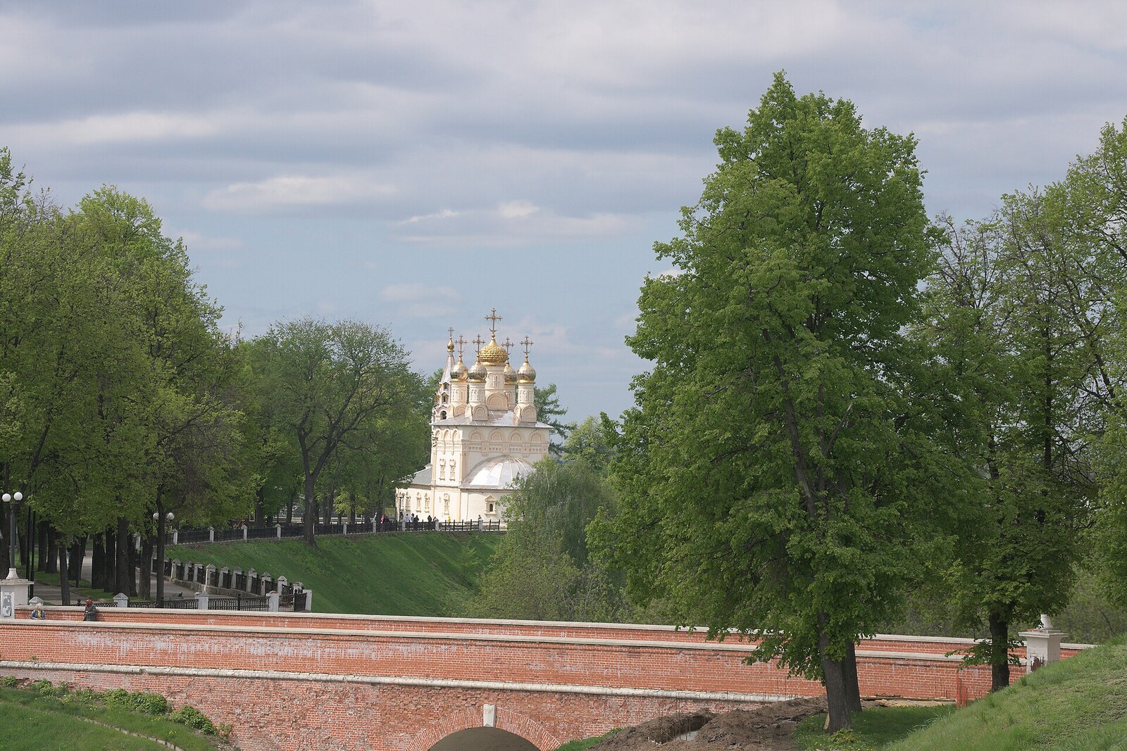 The Church of the Saviour-on-the-Ravine on a high bank beyond a brick bridge