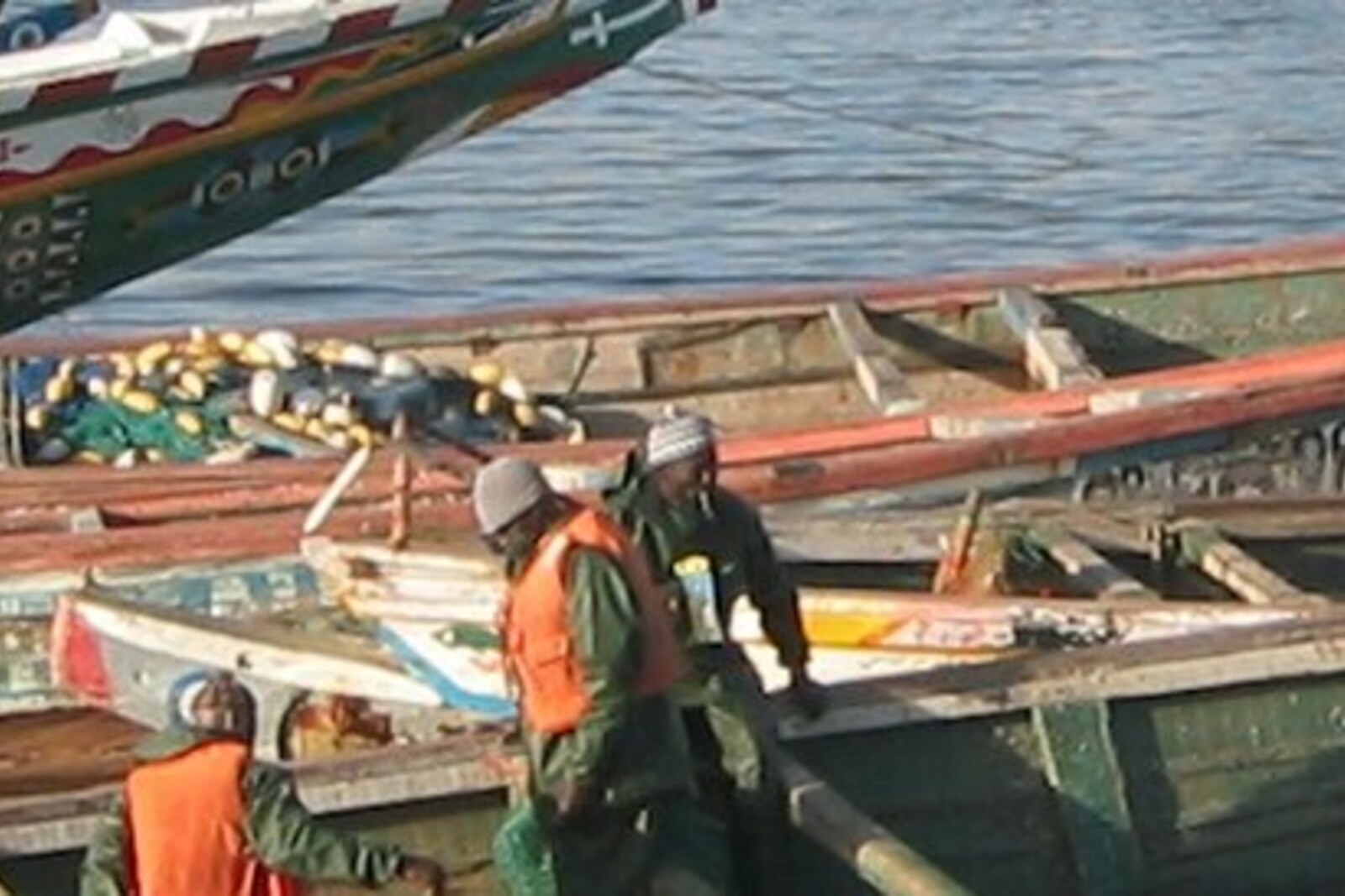 Painted Saint-Louis pirogues by the water, beside the fishing side of the city.