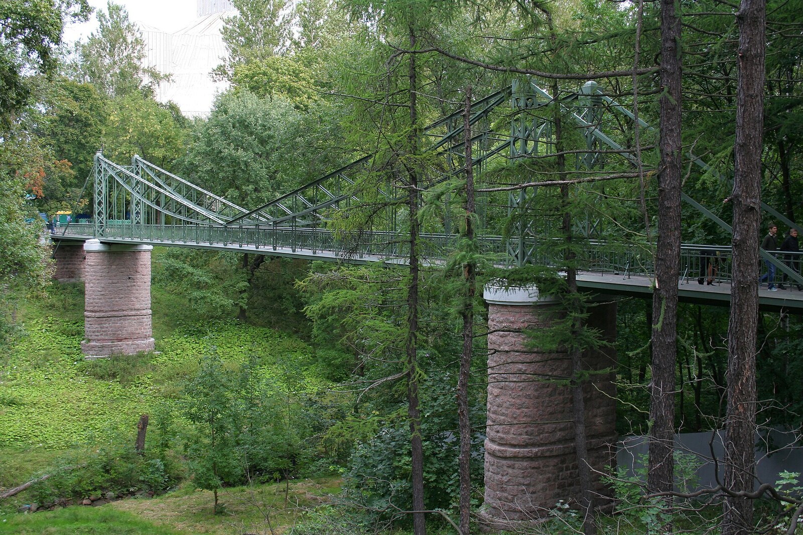The narrow suspension Makarov Bridge between stone abutments.