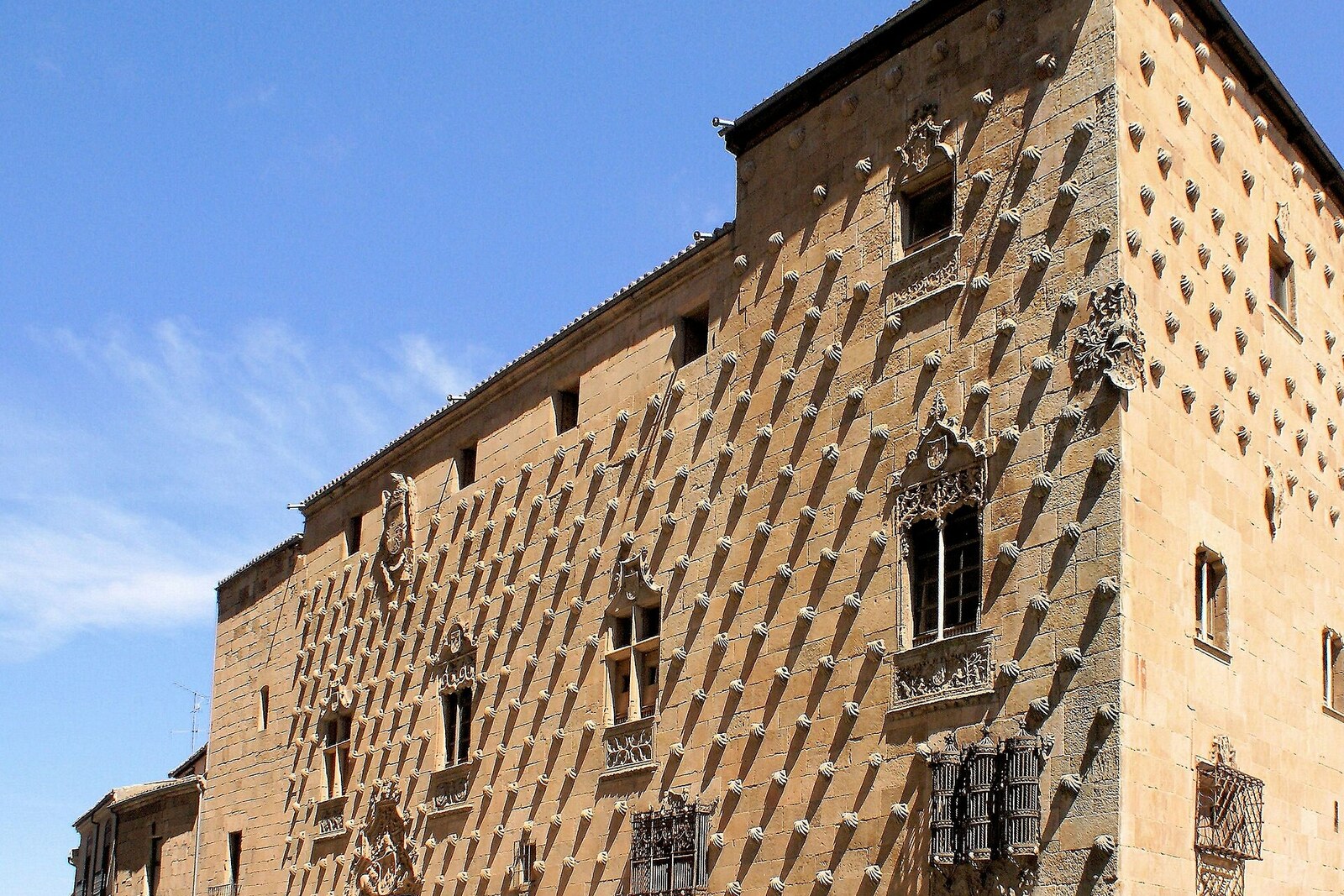 The facade of Casa de las Conchas, covered with rows of stone shells.