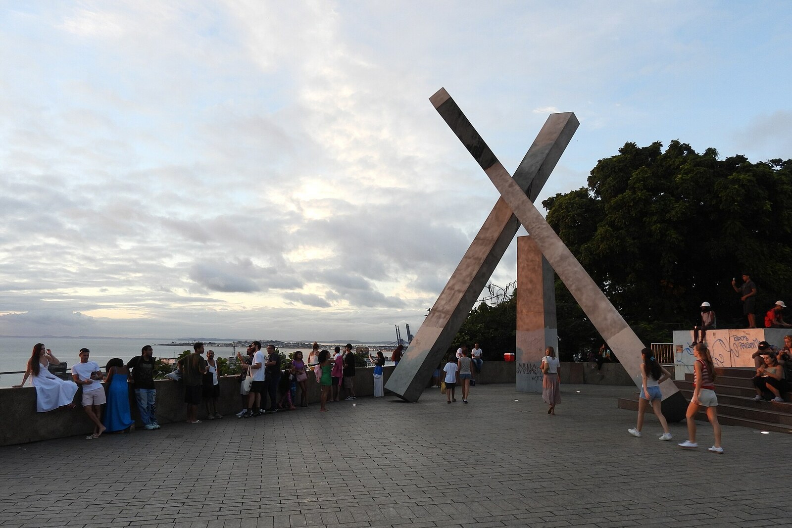 The stainless-steel Fallen Cross monument above the bay